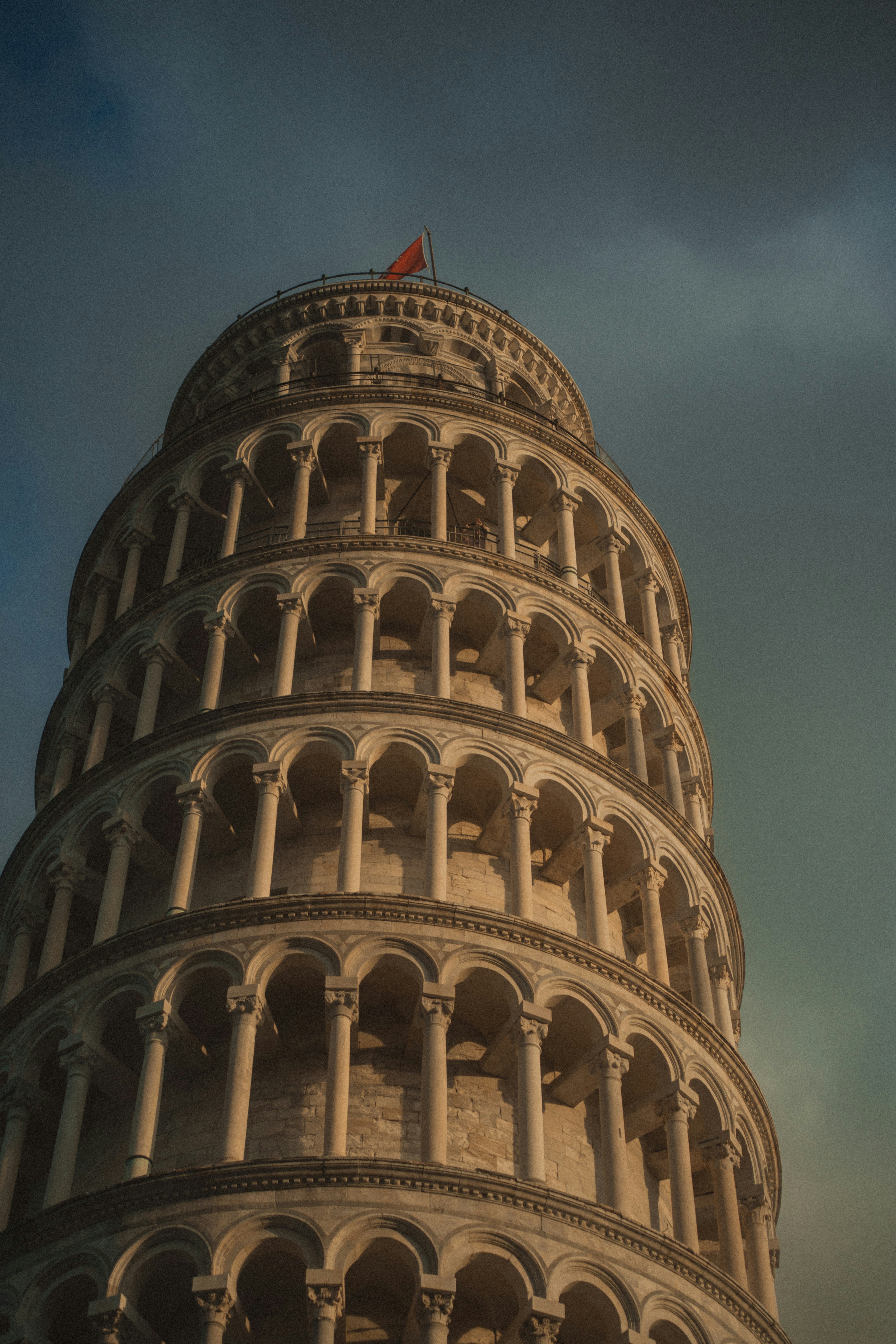 The leaning tower of pisa against a cloudy sky