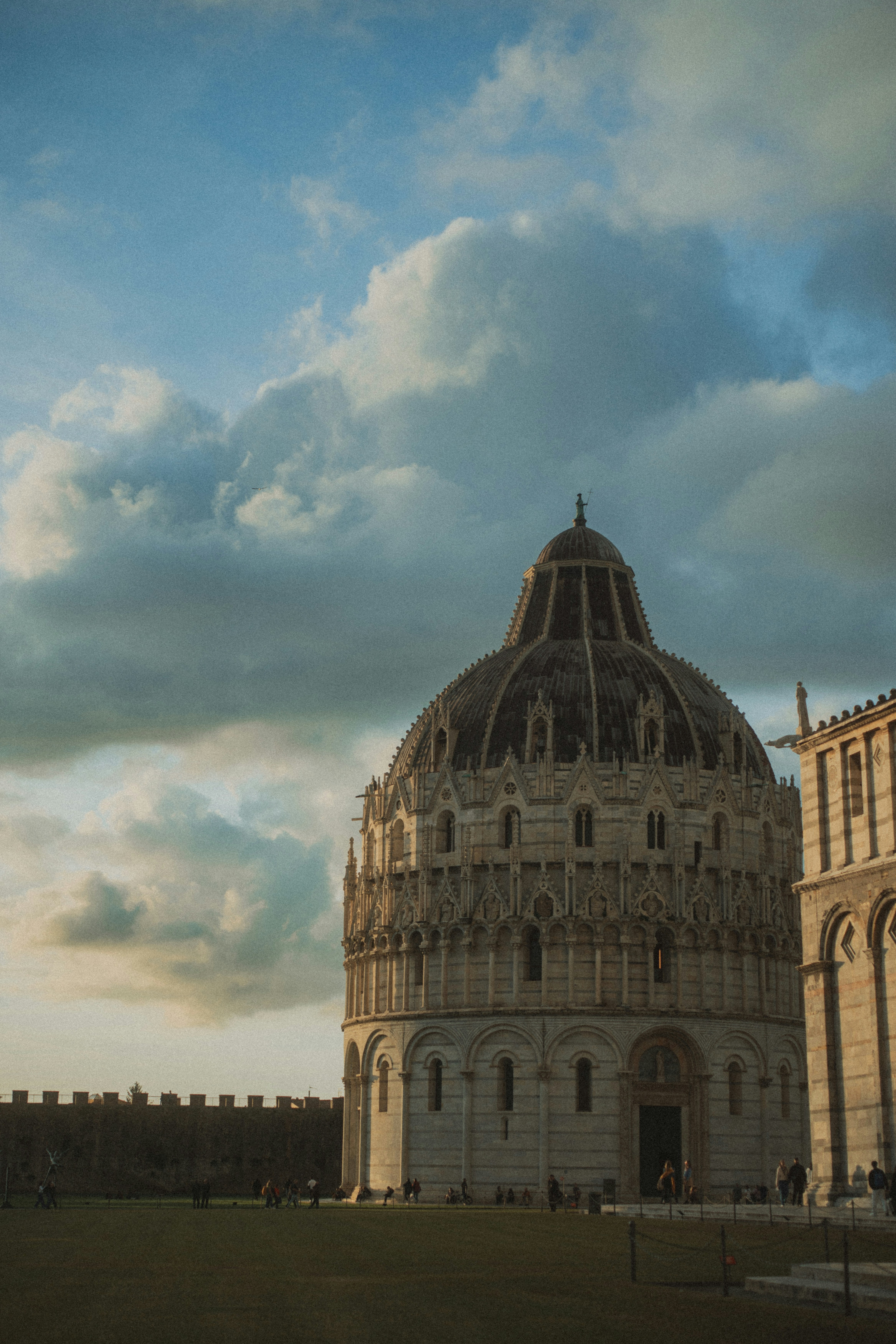 Ornate building with a domed roof under cloudy sky