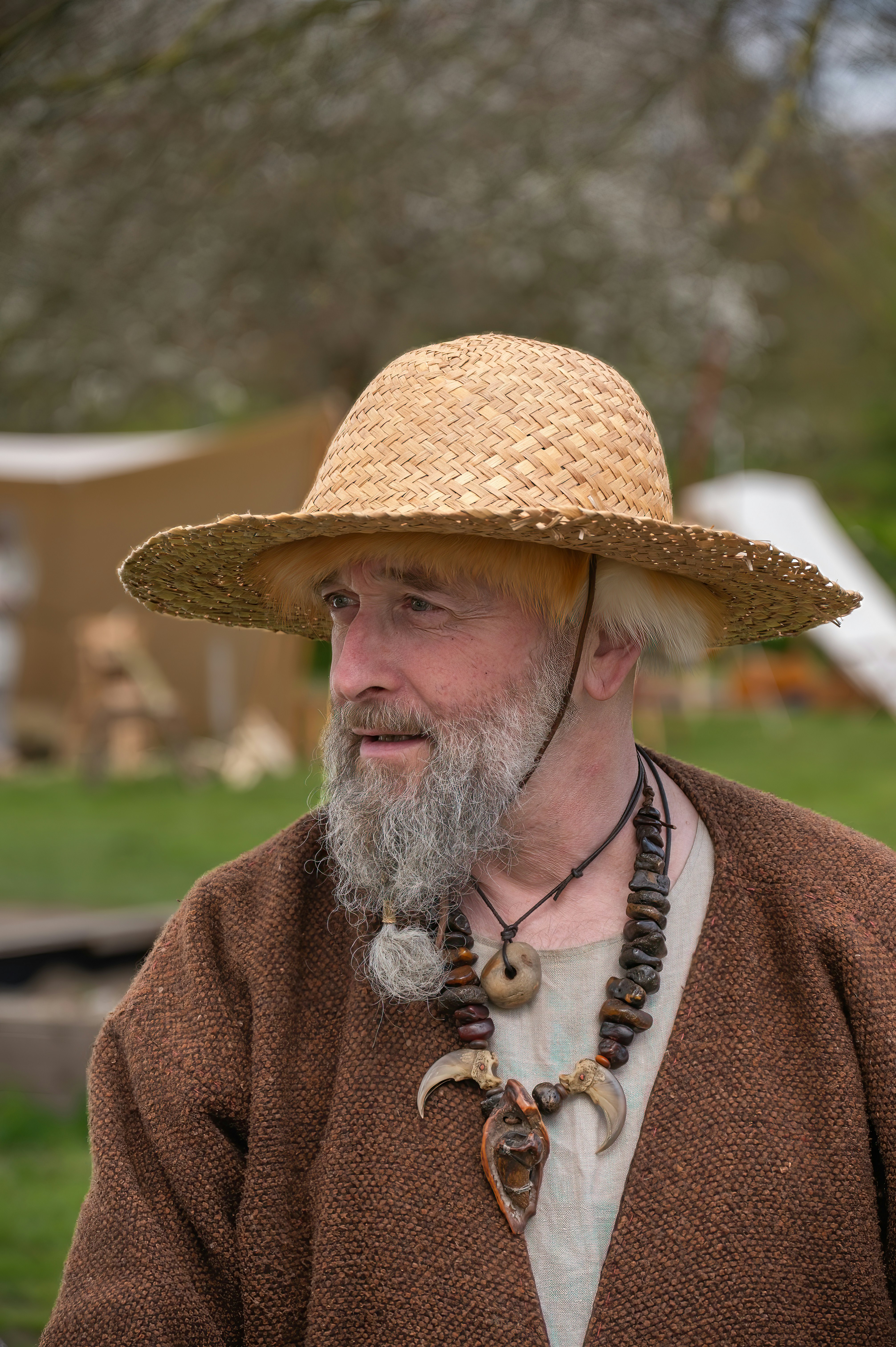 Man with straw hat and tribal necklace