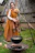 Woman in historical costume by cooking pot