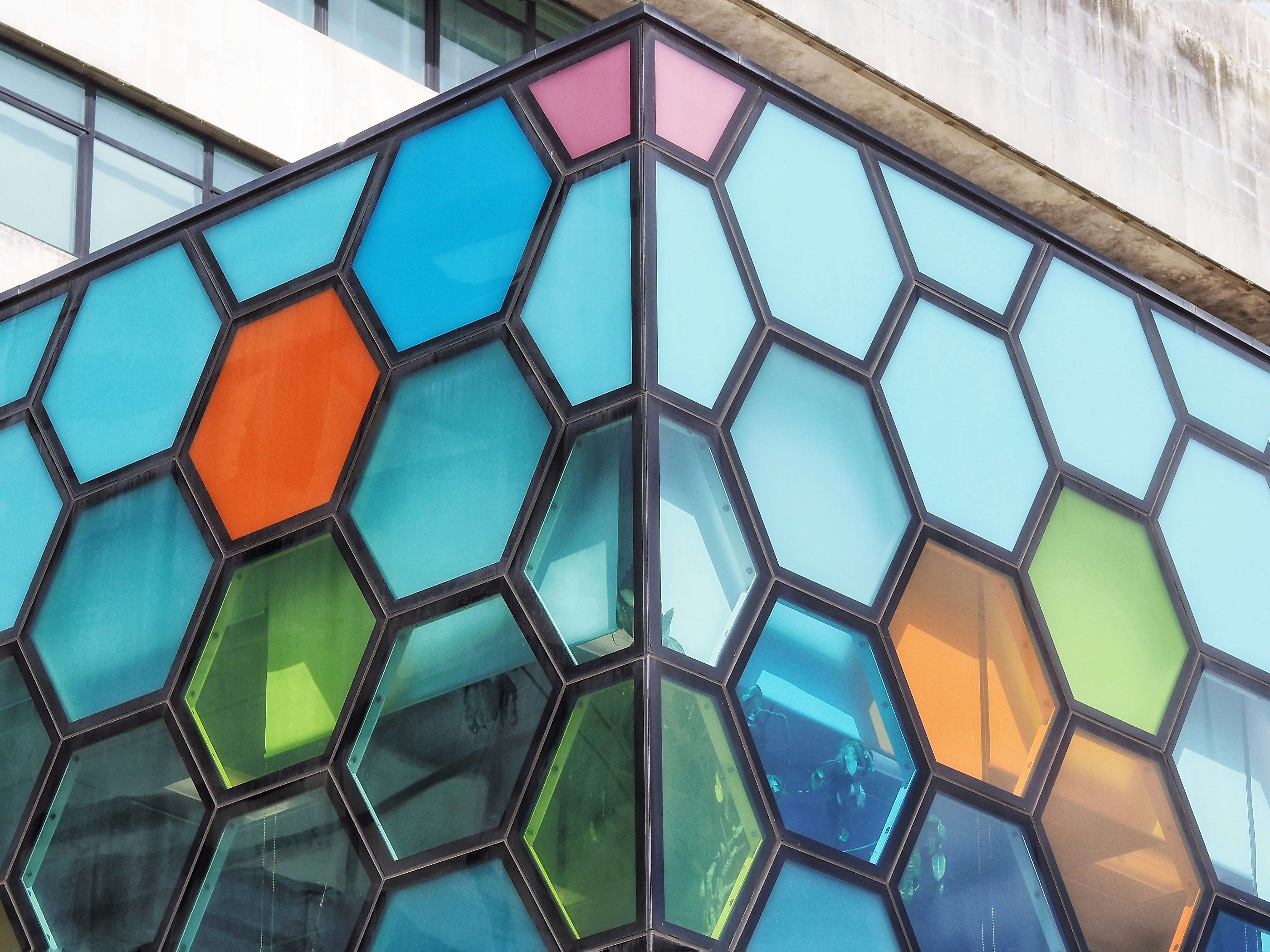 Building corner with colorful hexagonal stained glass windows