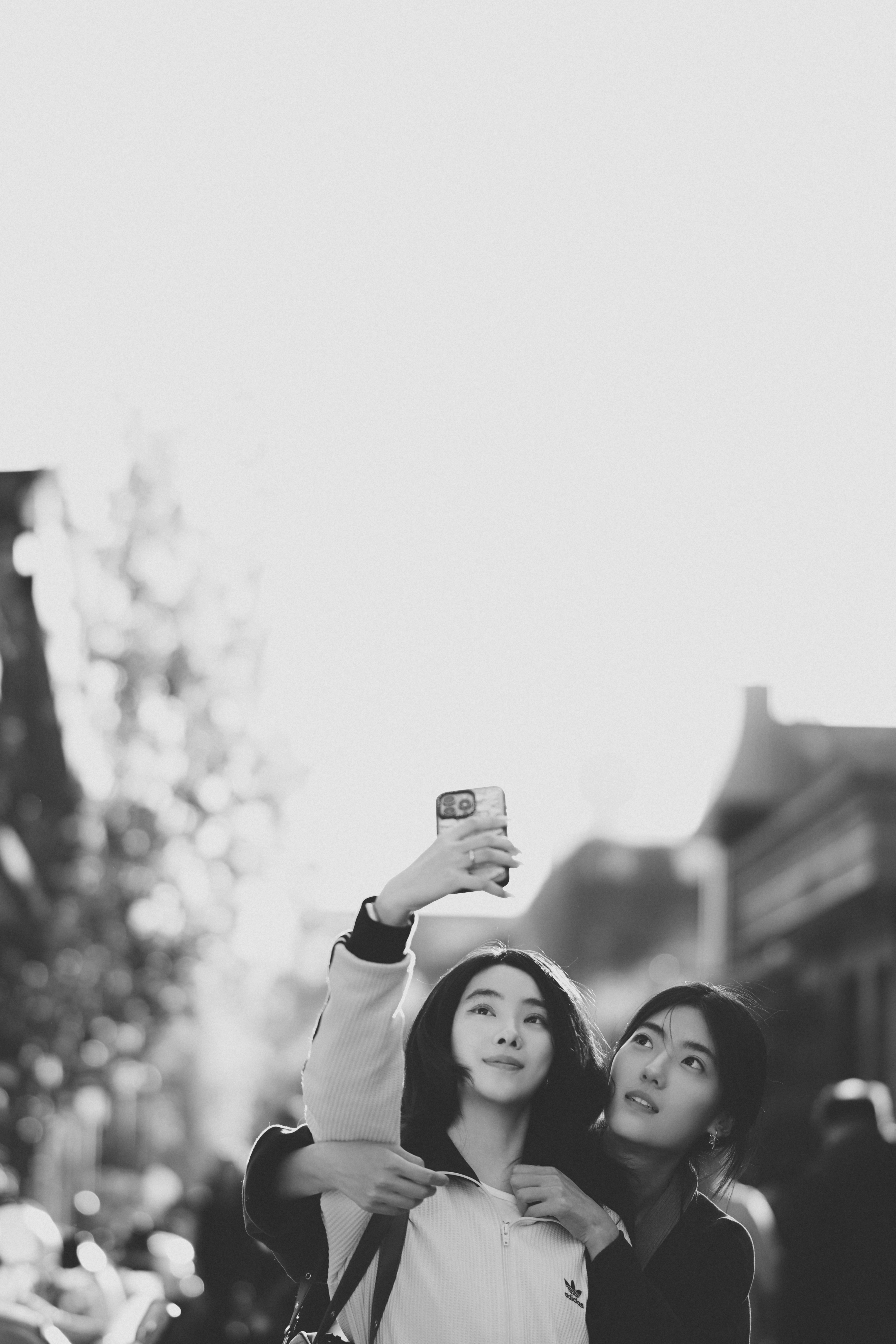Two young women taking a selfie outdoors