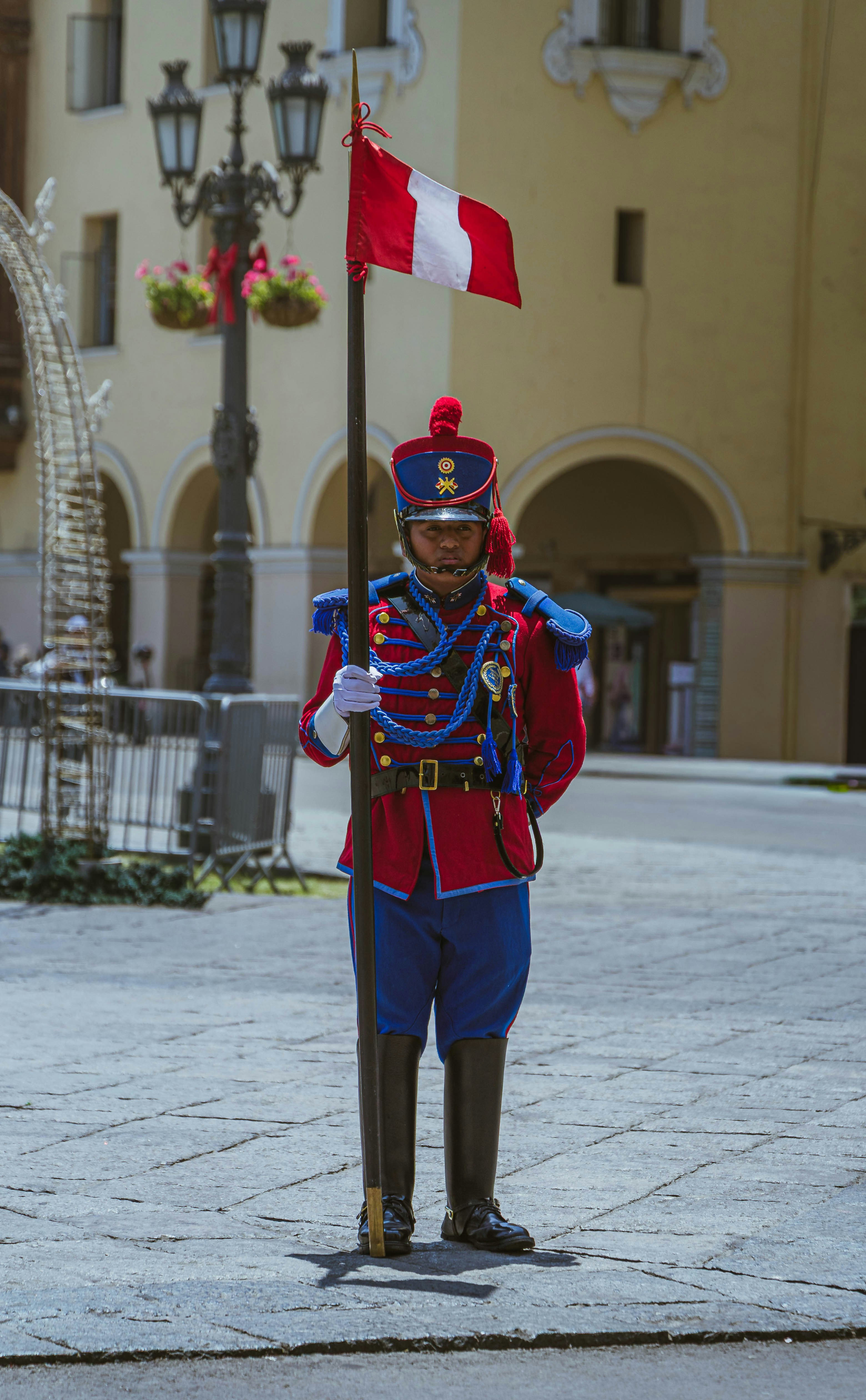 Guard in uniform holding a peruvian flag