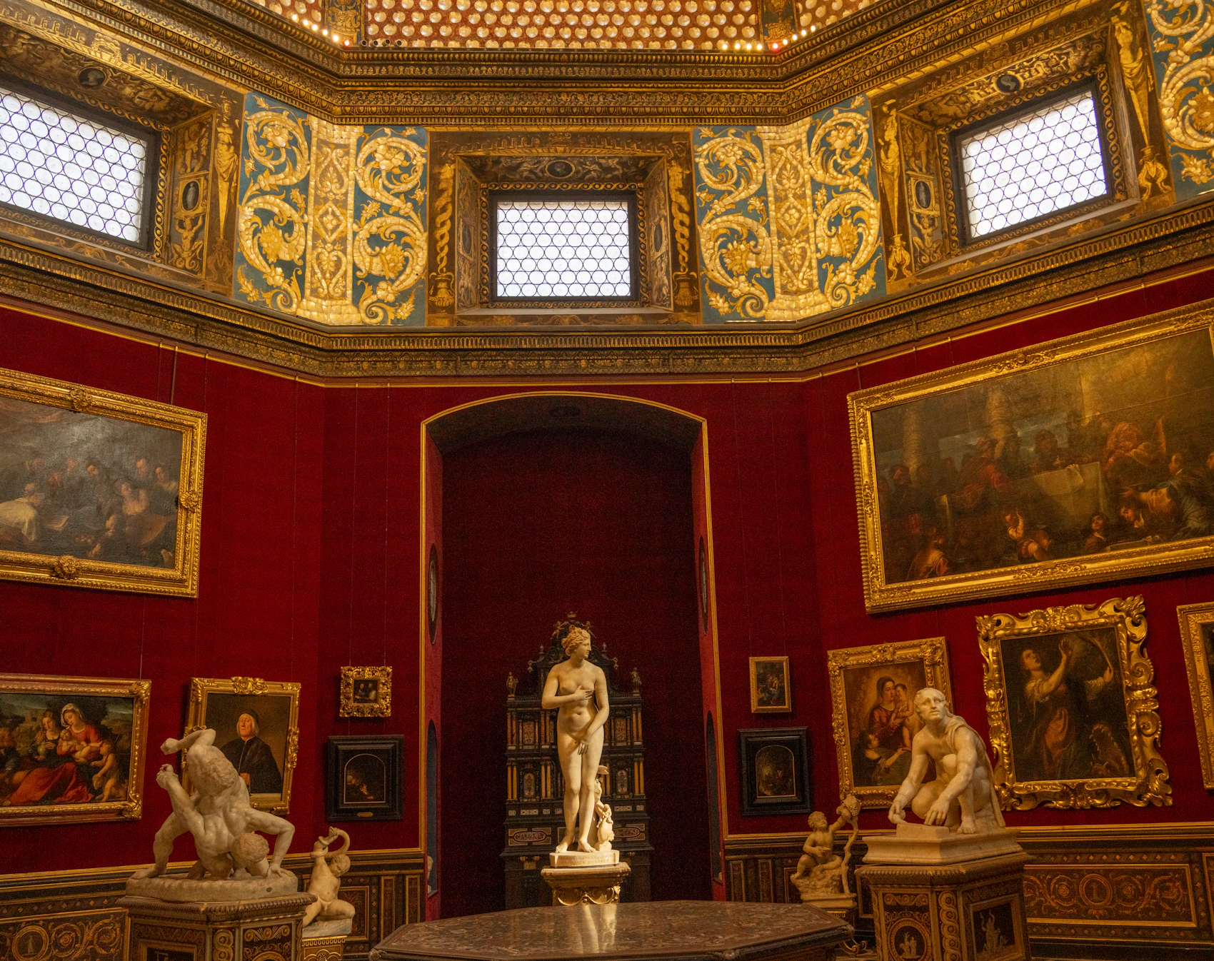 A richly decorated gallery of Renaissance paintings and sculpture inside the Uffizi in Florence