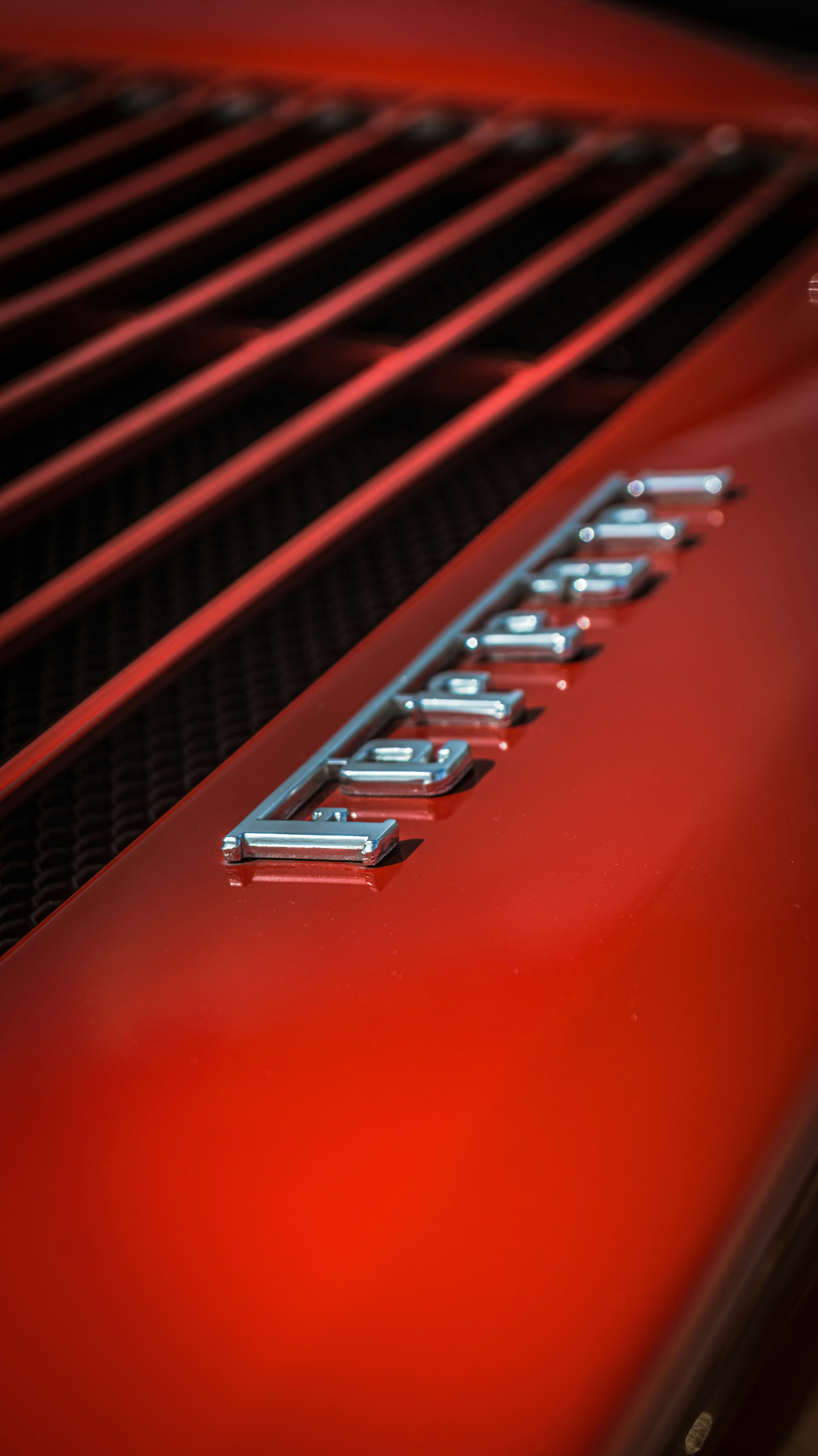 Chrome lettering on a red car