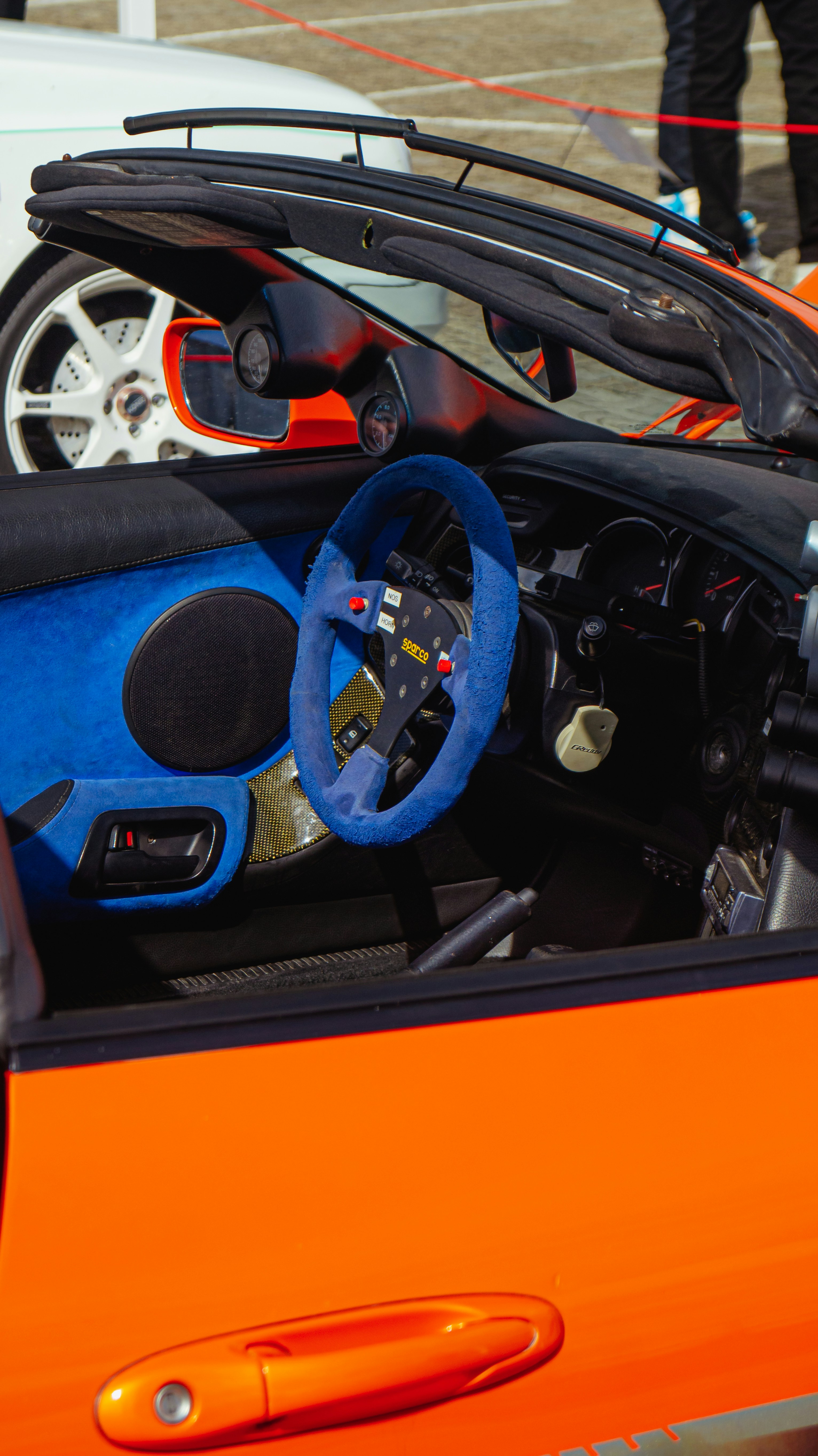 Interior of an orange sports car with blue accents.