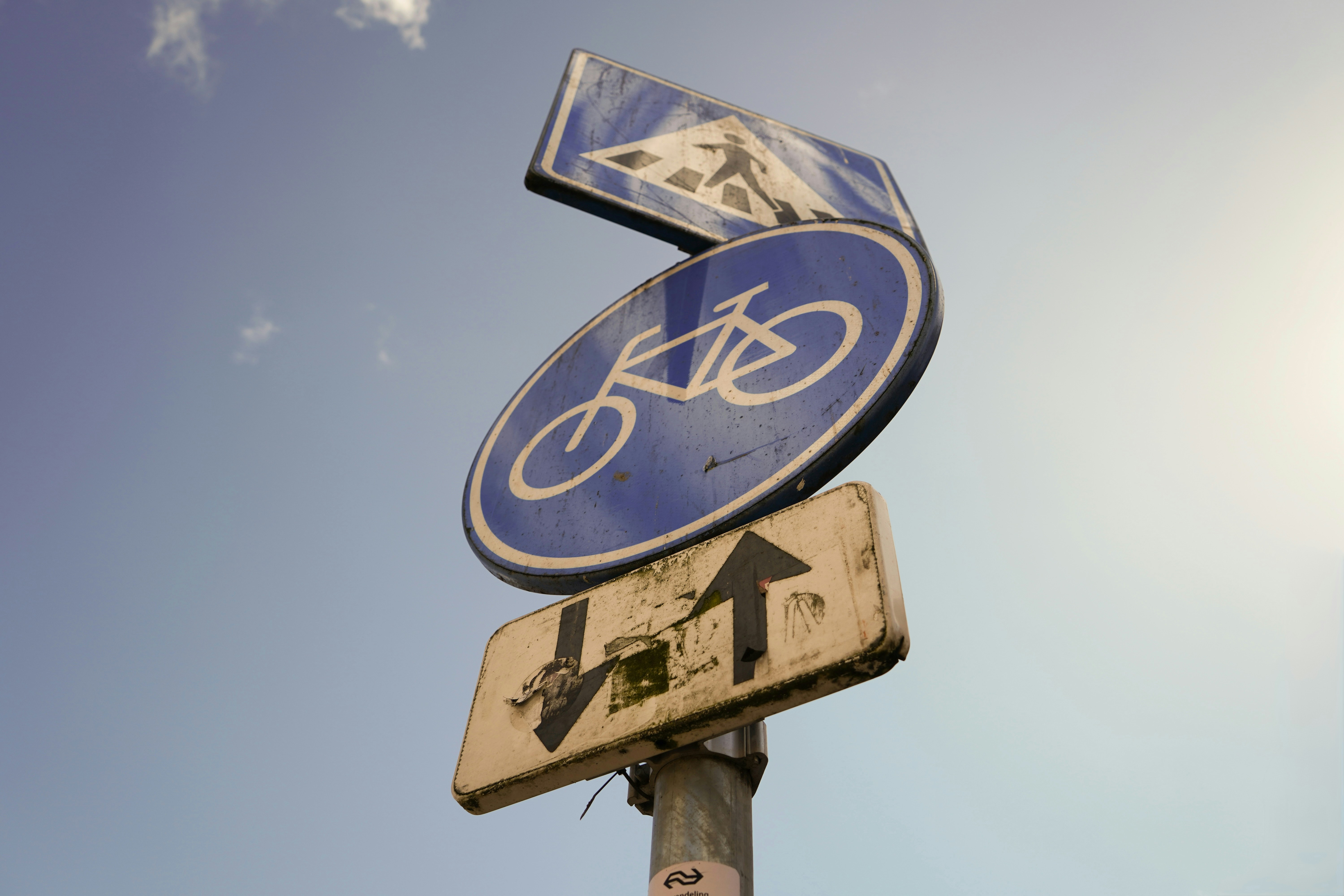 Stack of road signs against a blue sky