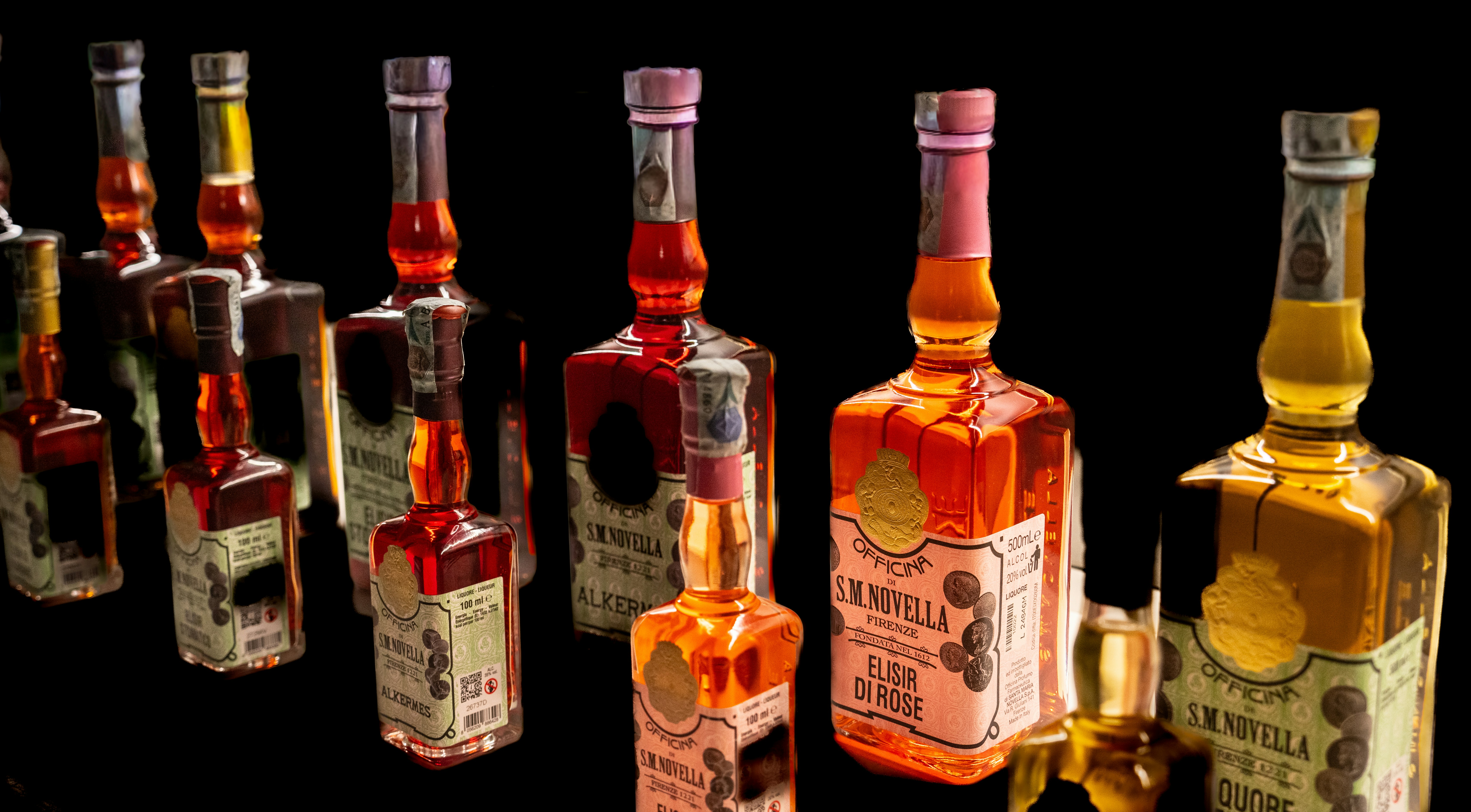 Assortment of vintage liquor bottles on black background