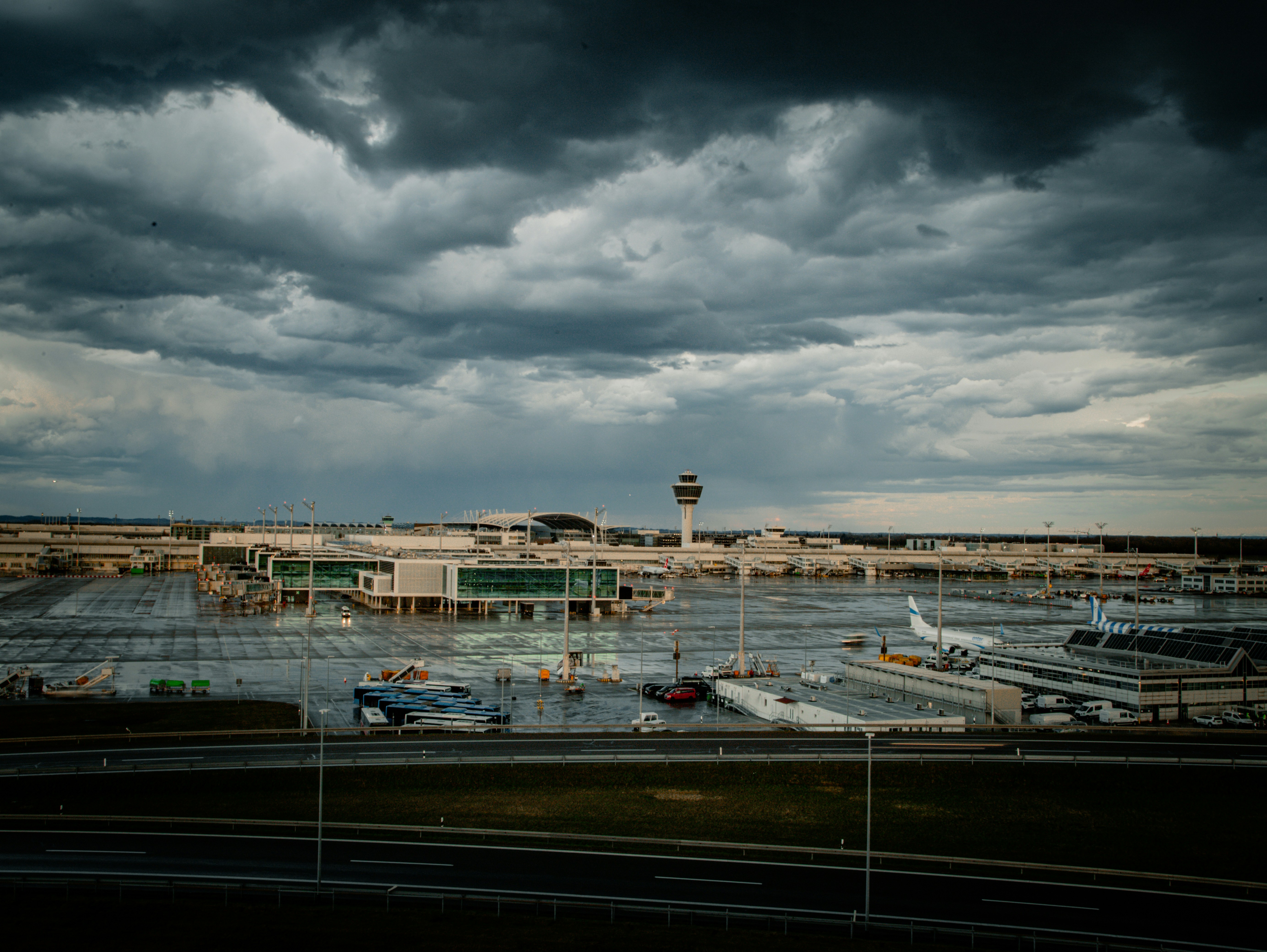 Modern airport terminal under dramatic stormy skies