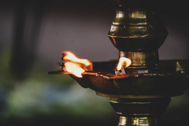 A lit brass oil lamp