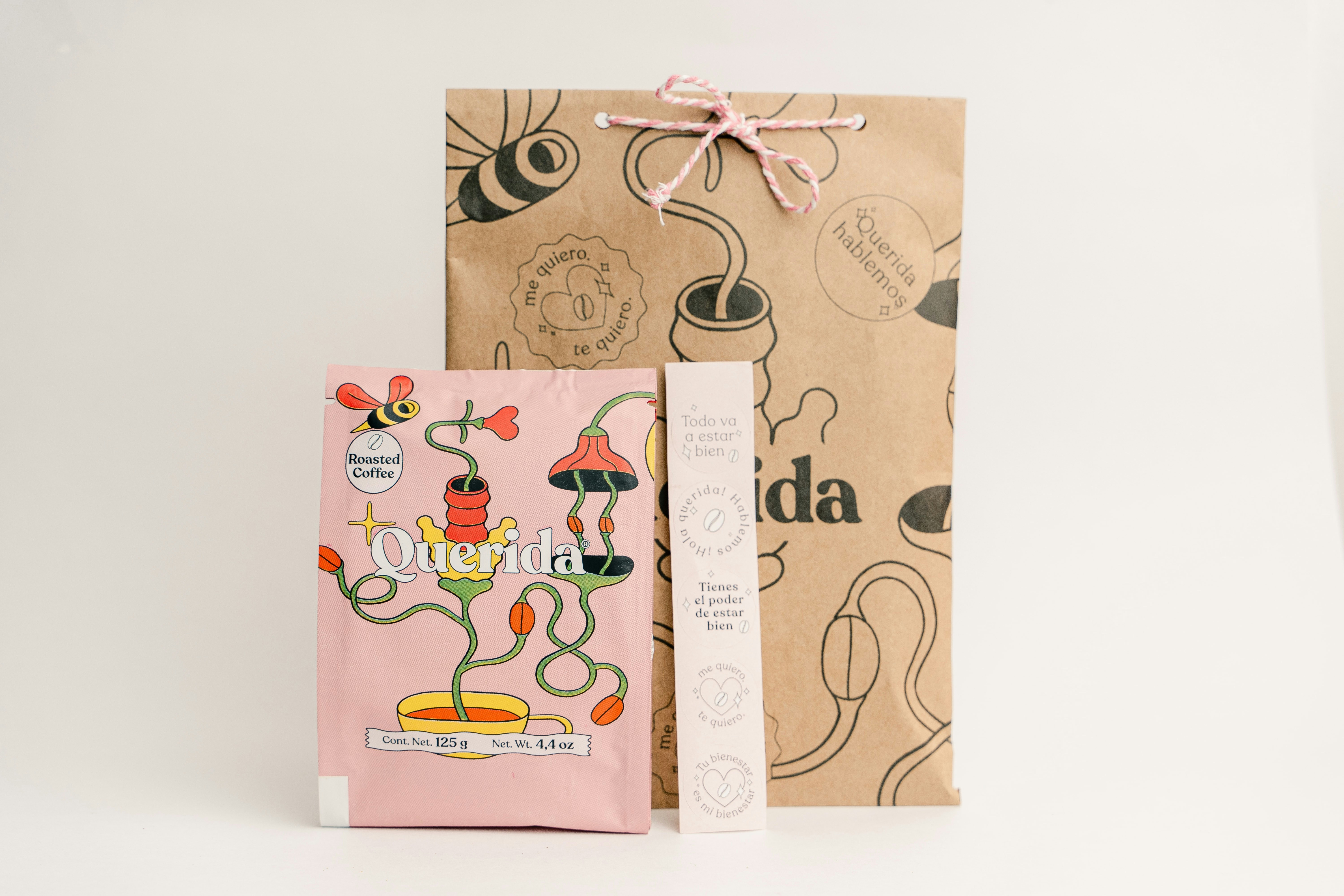 Gift bag with tea and a pink floral packet