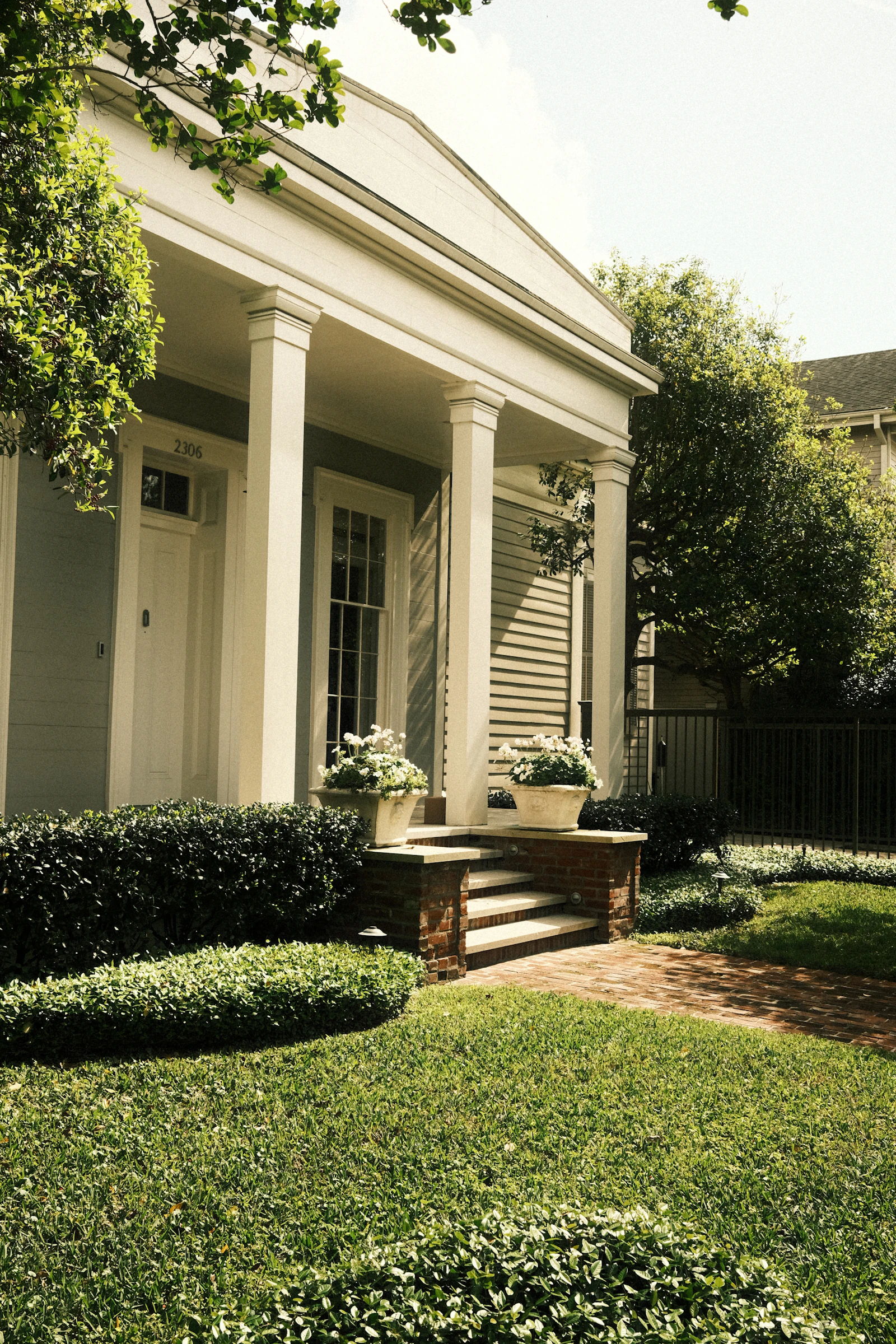 Charming home with white columns and landscaping