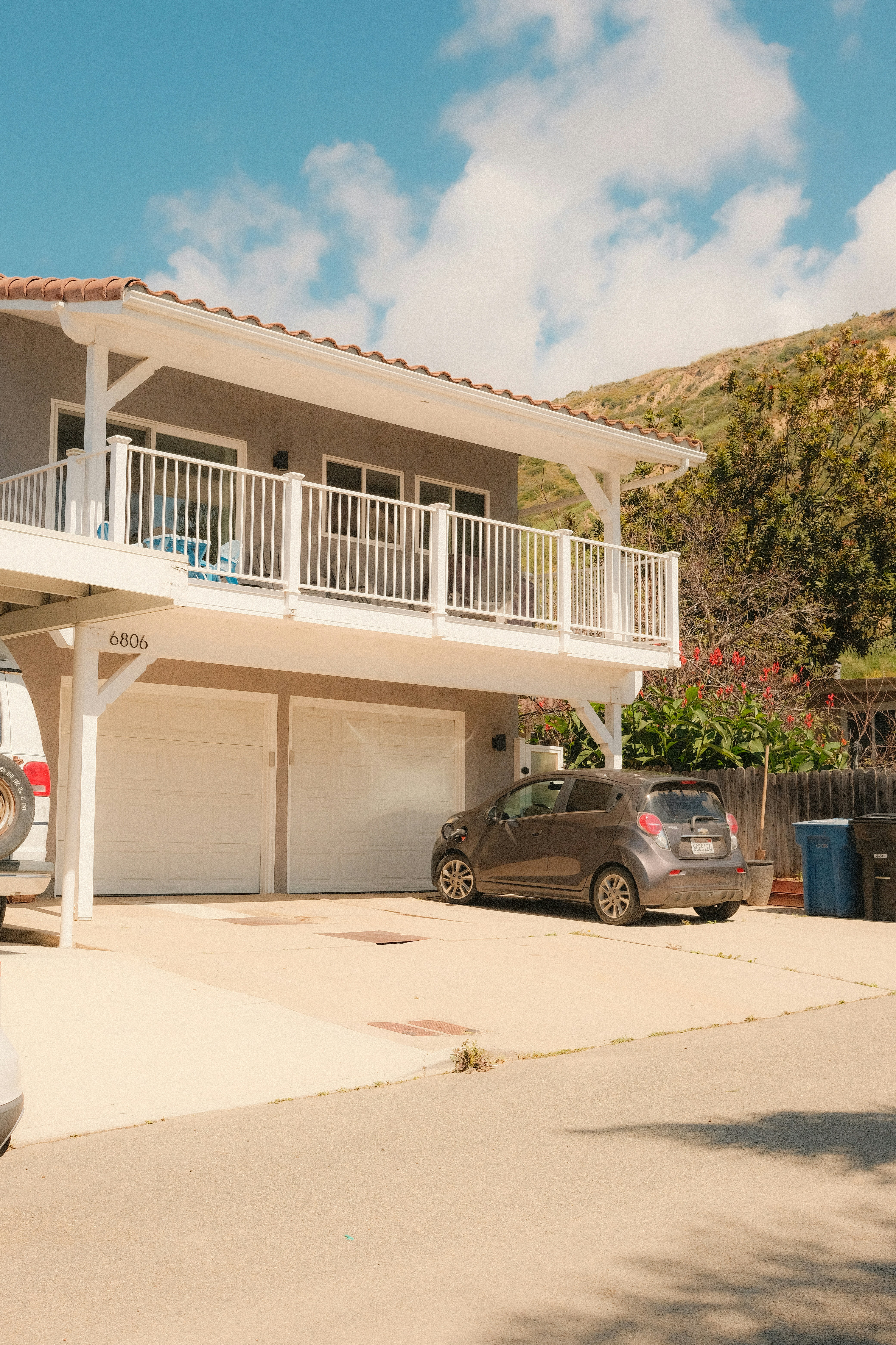 A modern house with a two-car garage and balcony.