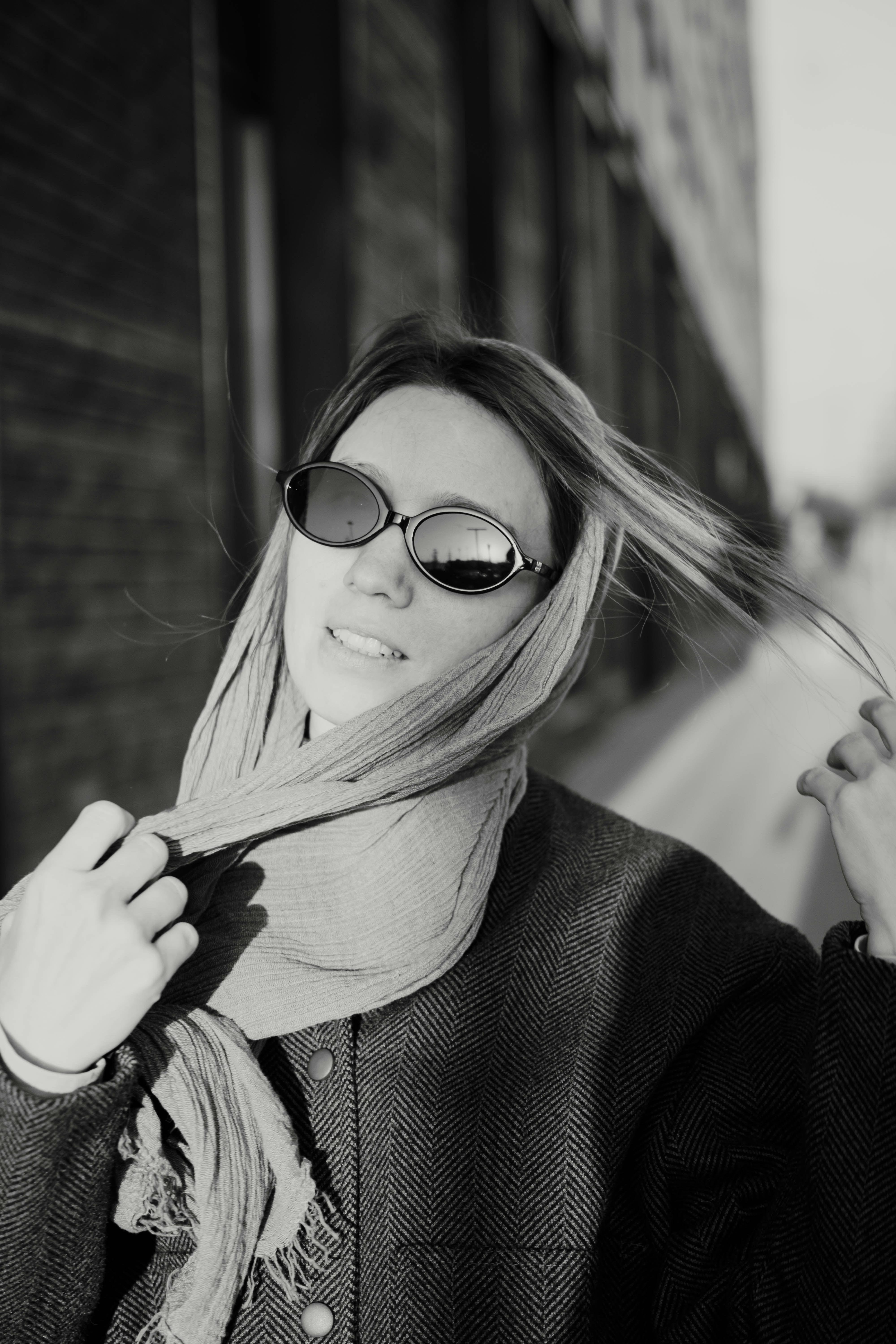 Woman wearing sunglasses and scarf outdoors