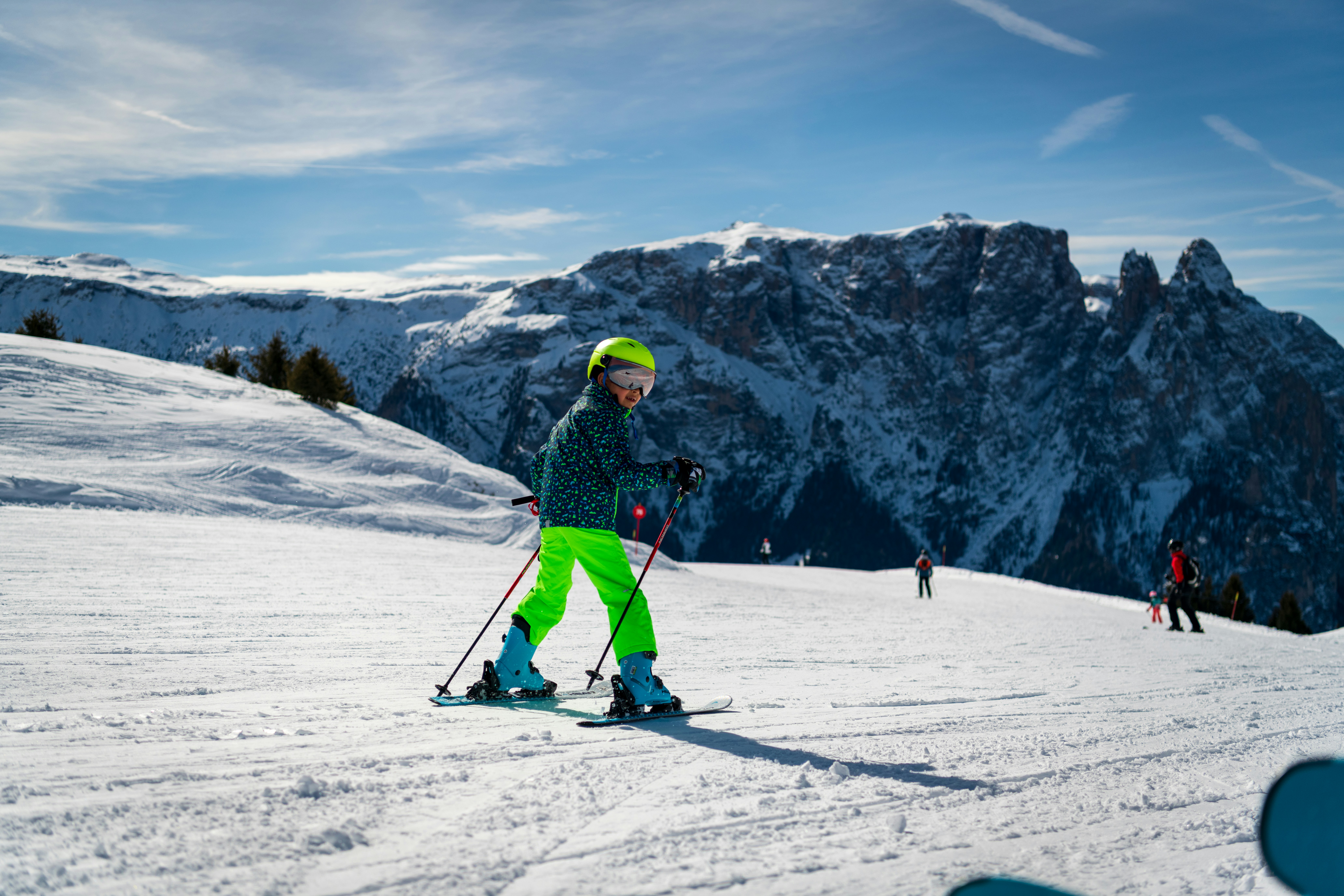 Child skiing down a snowy mountain slope