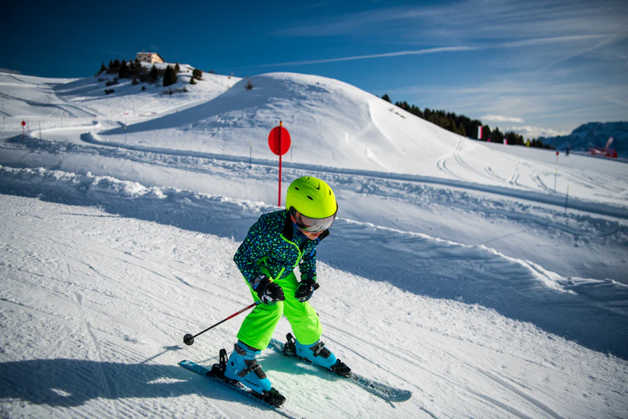 Child skiing down a snowy mountain slope