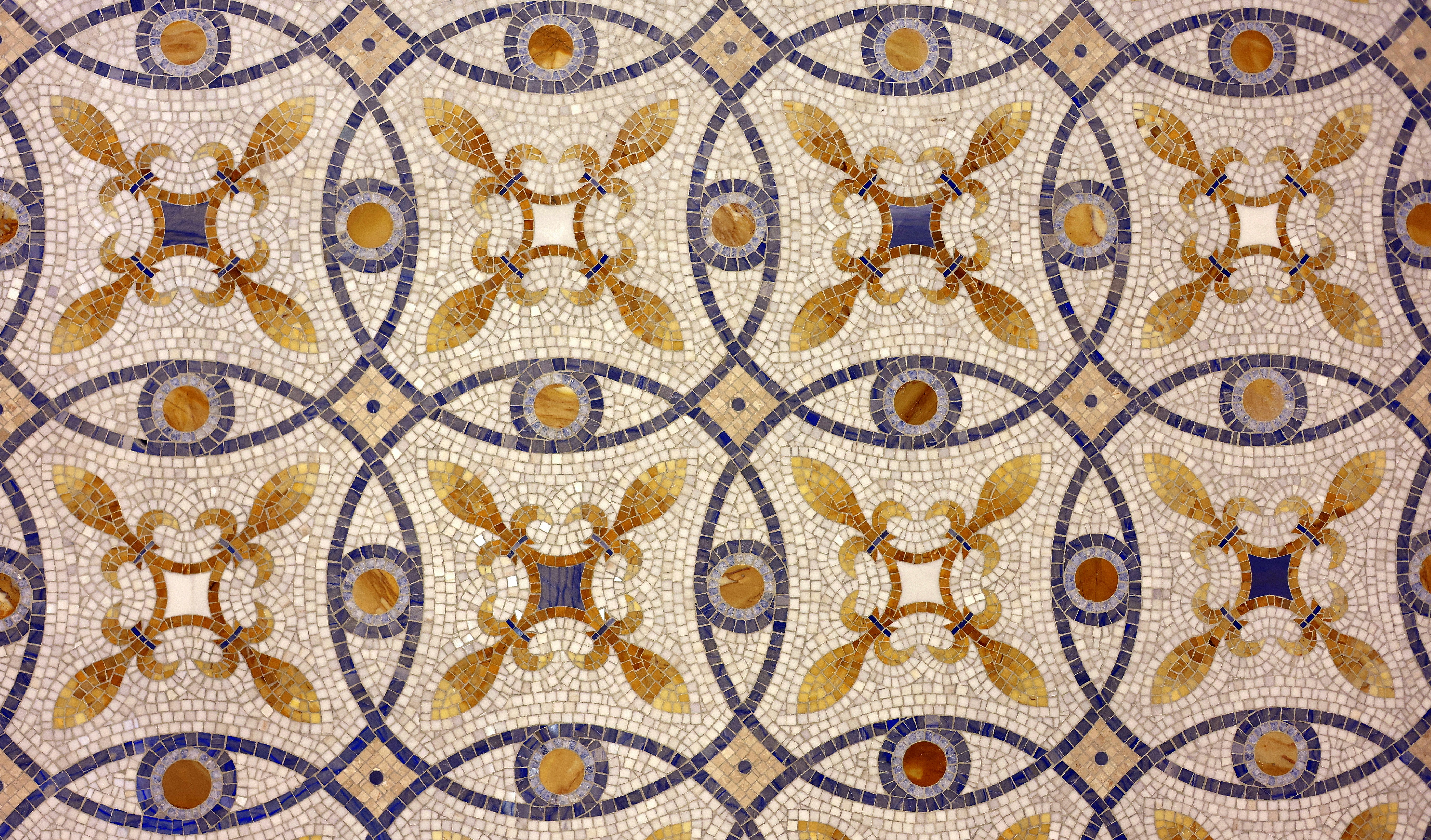 Intricate mosaic tile pattern with floral and eye motifs
