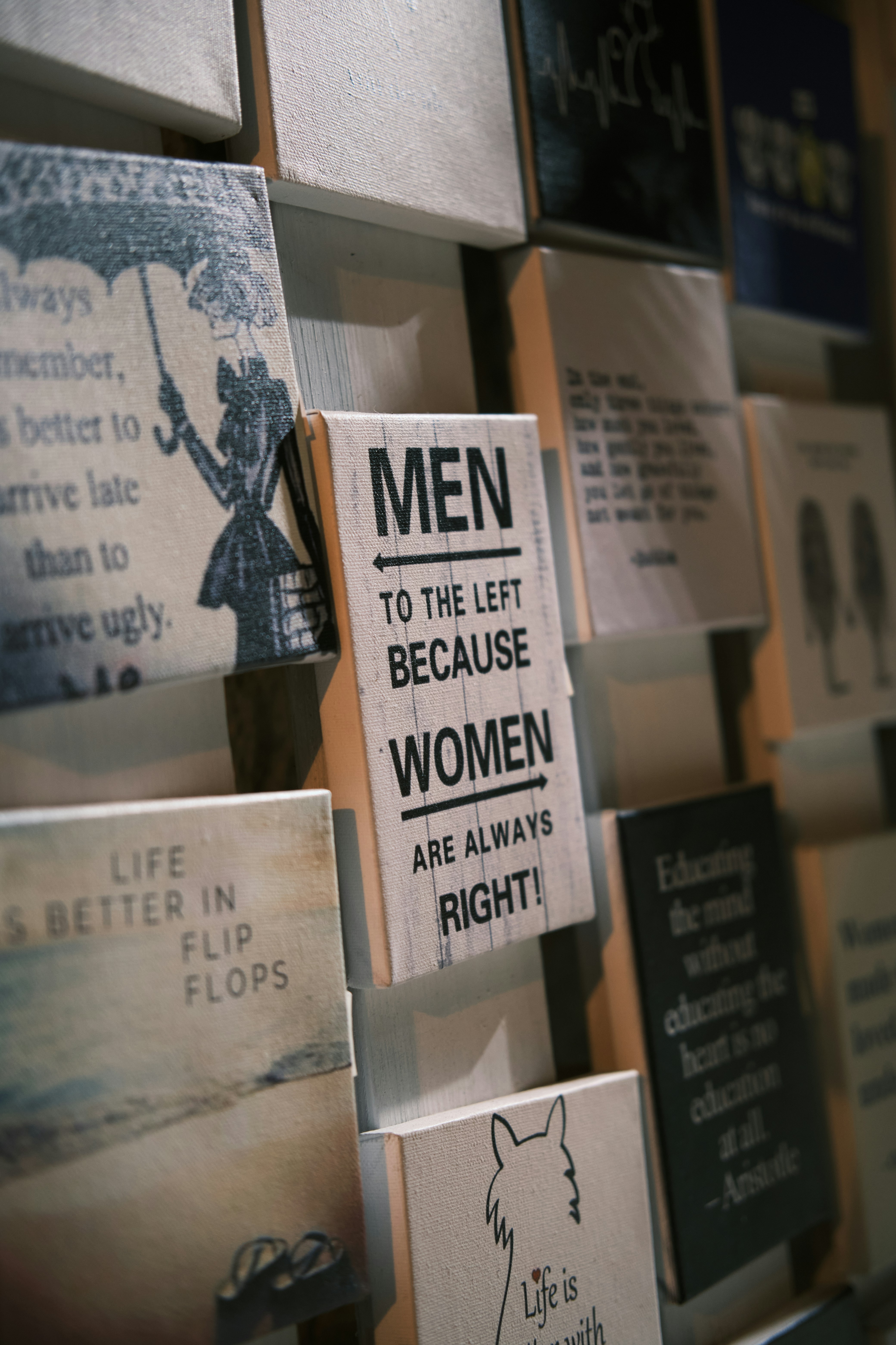 Wooden signs with various quotes and designs displayed art displayed.