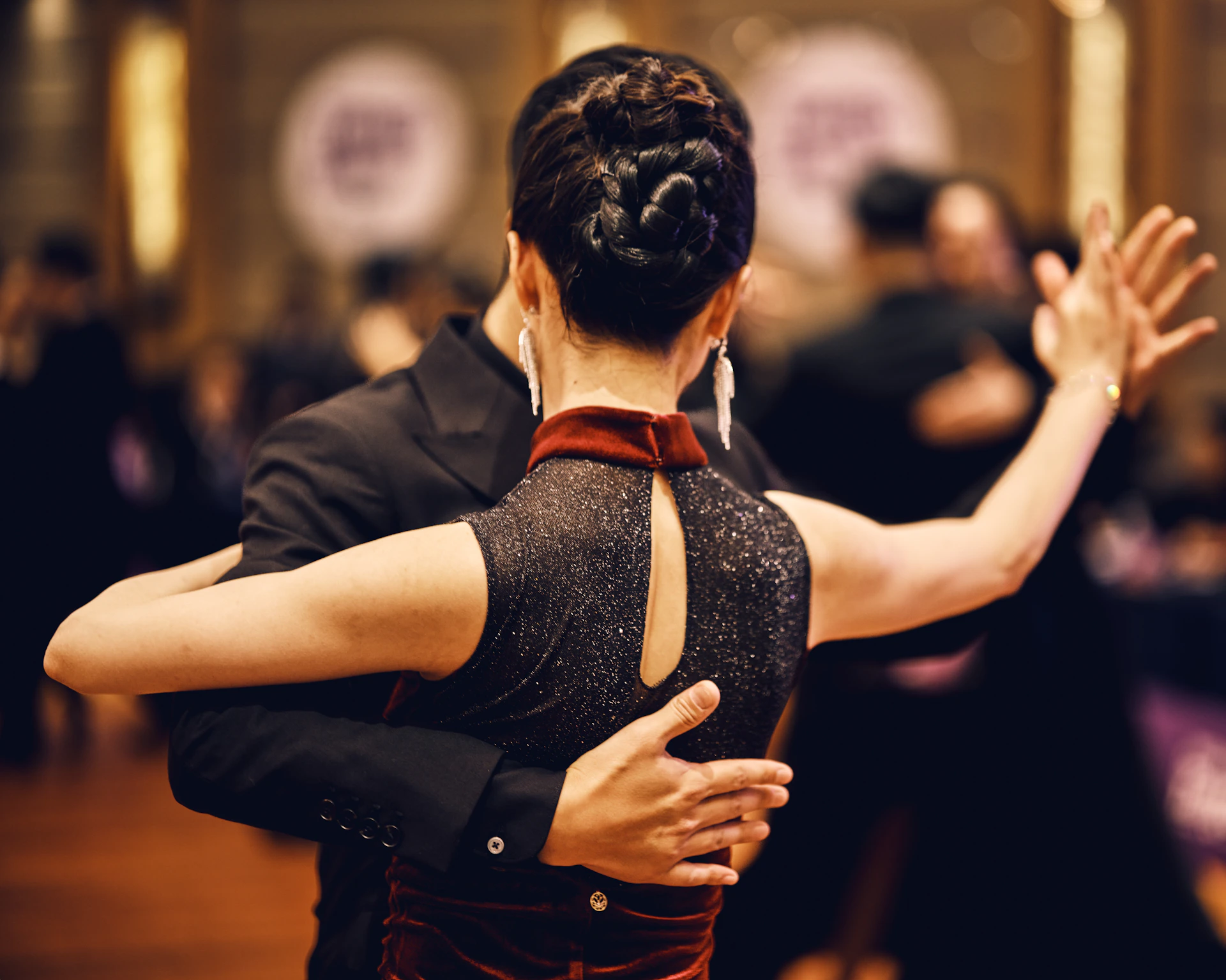 Couple dancing tango in a ballroom