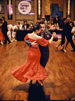 A couple dances tango in a ballroom