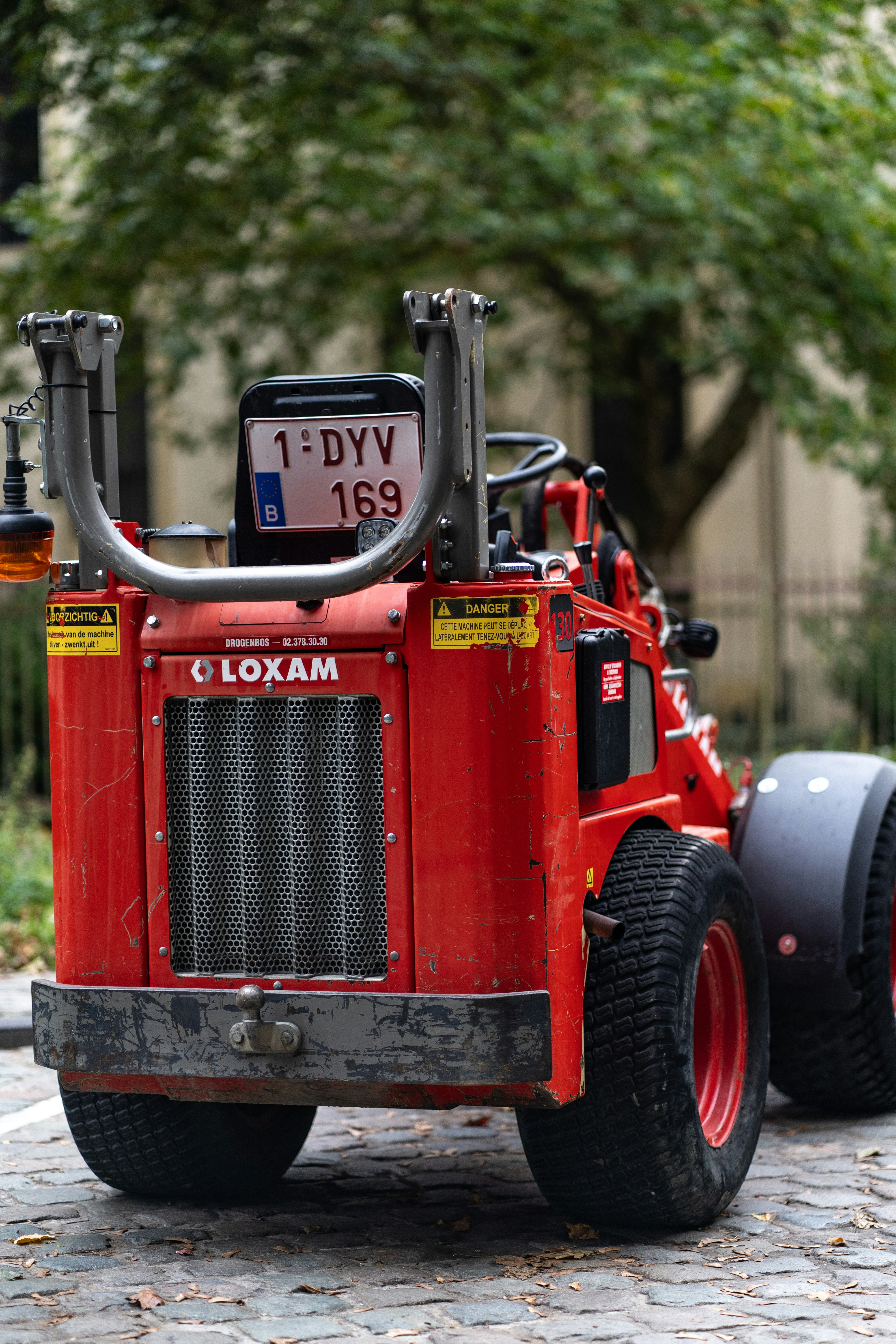 Red loxam construction vehicle with license plate