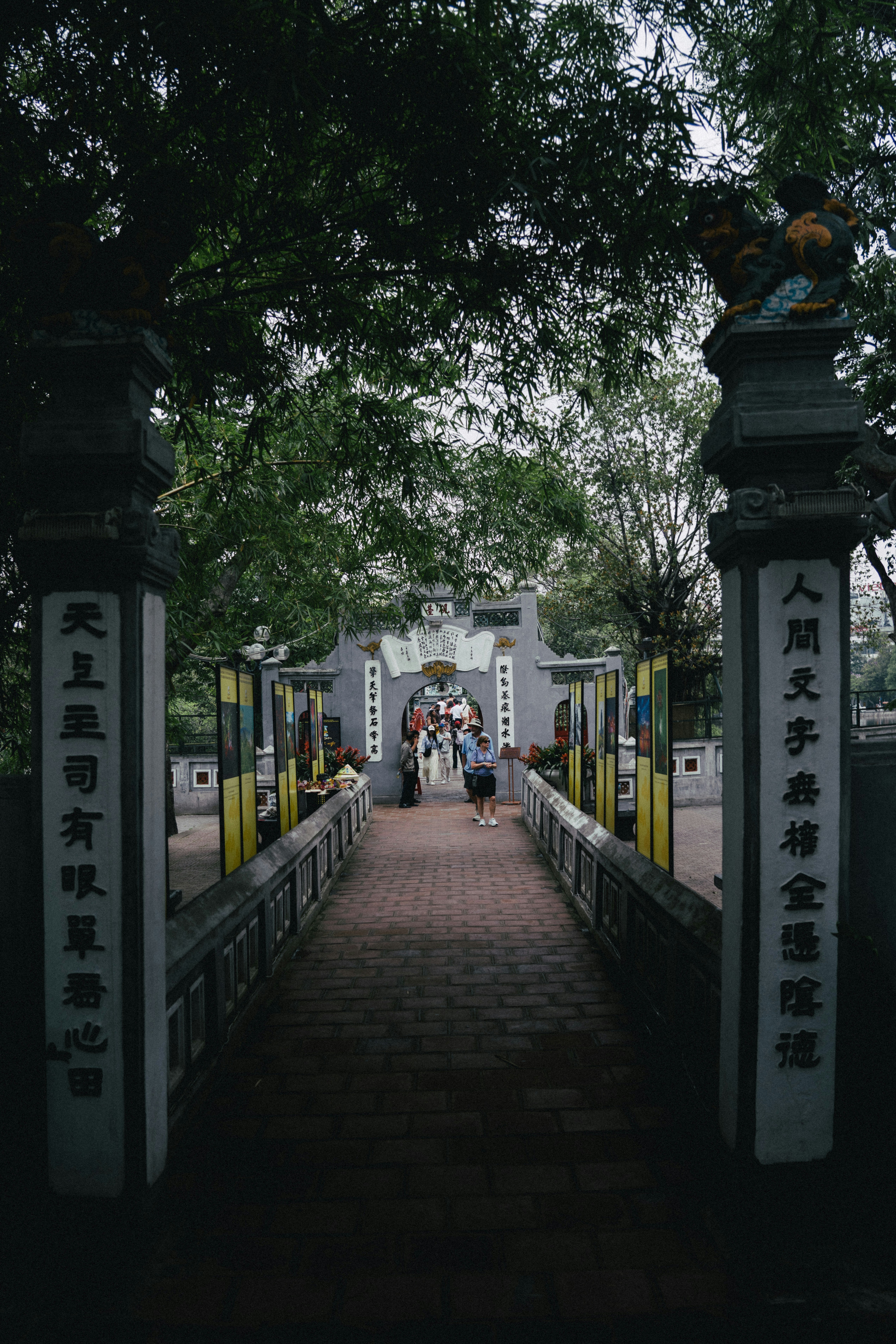 Pathway leading to an ornate temple entrance with people