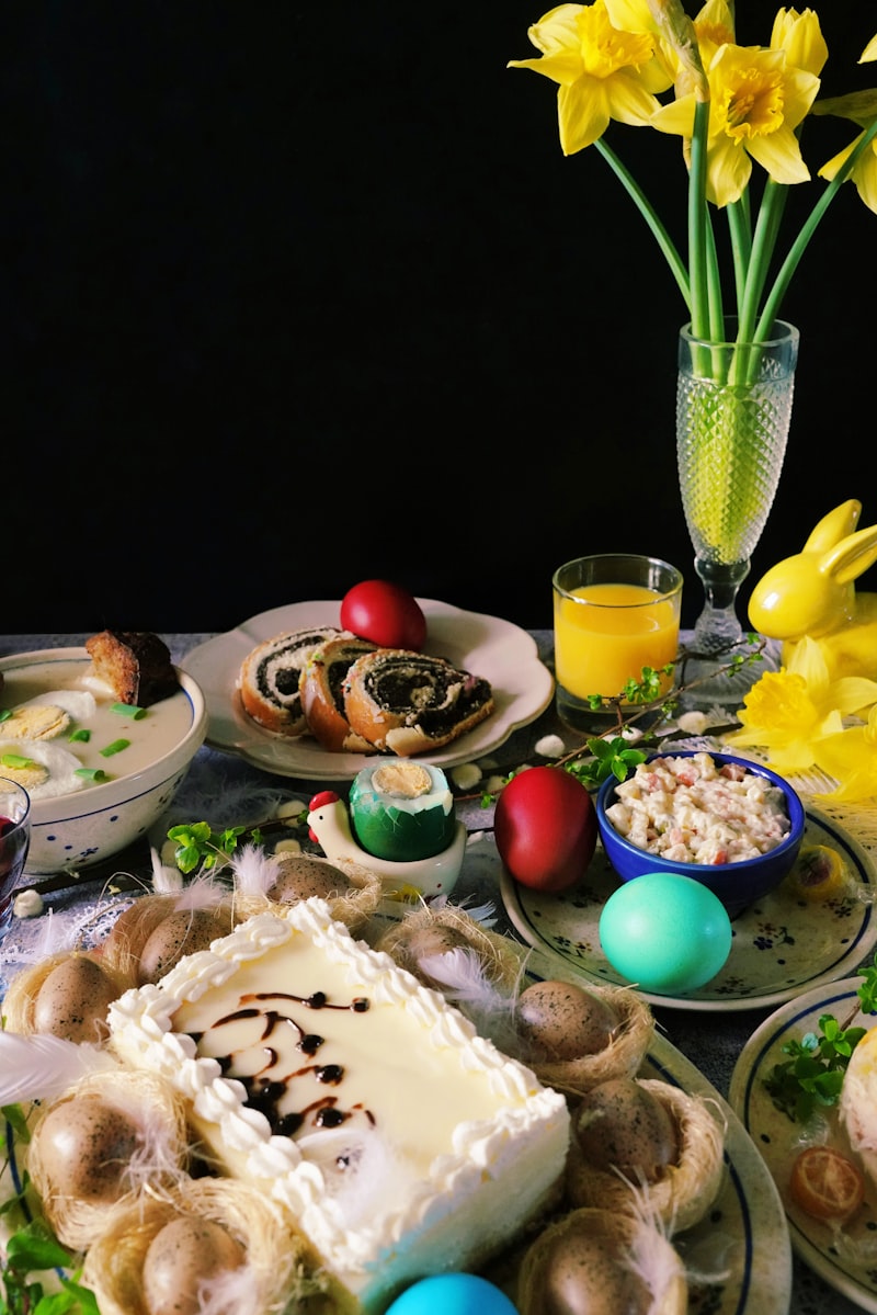 Sliced poppy seed roll on a holiday table with painted eggs and spring flowers