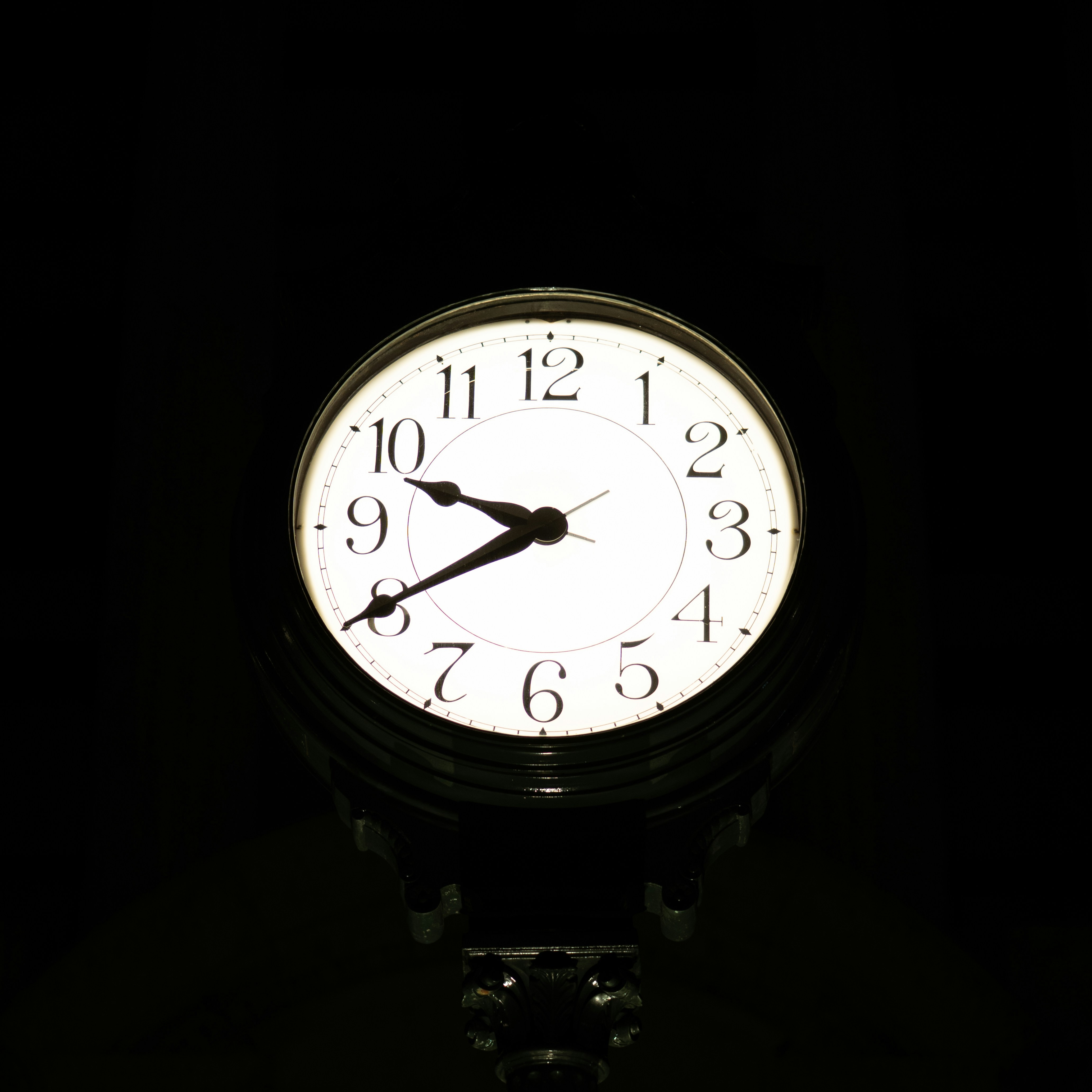 A clock face with hands pointing to 9:45