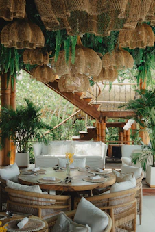 A tropical restaurant dining area with lush greenery.