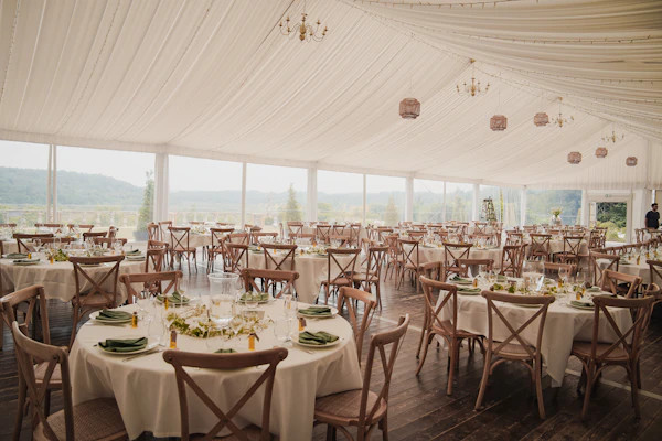 Marquee interior with round tables and draped ceiling