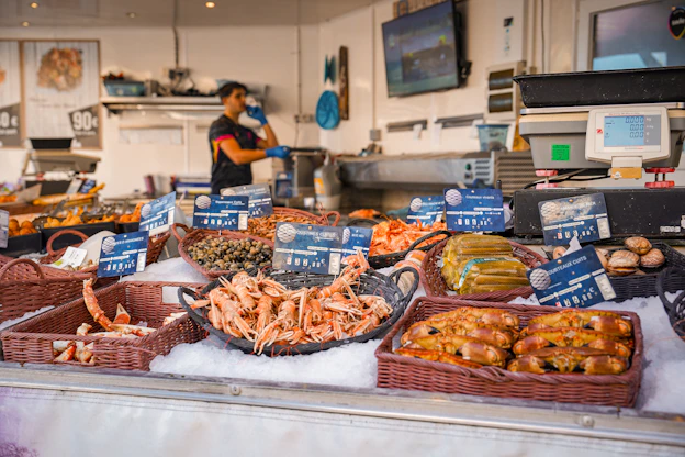 Fresh seafood displayed on ice at a market stall.