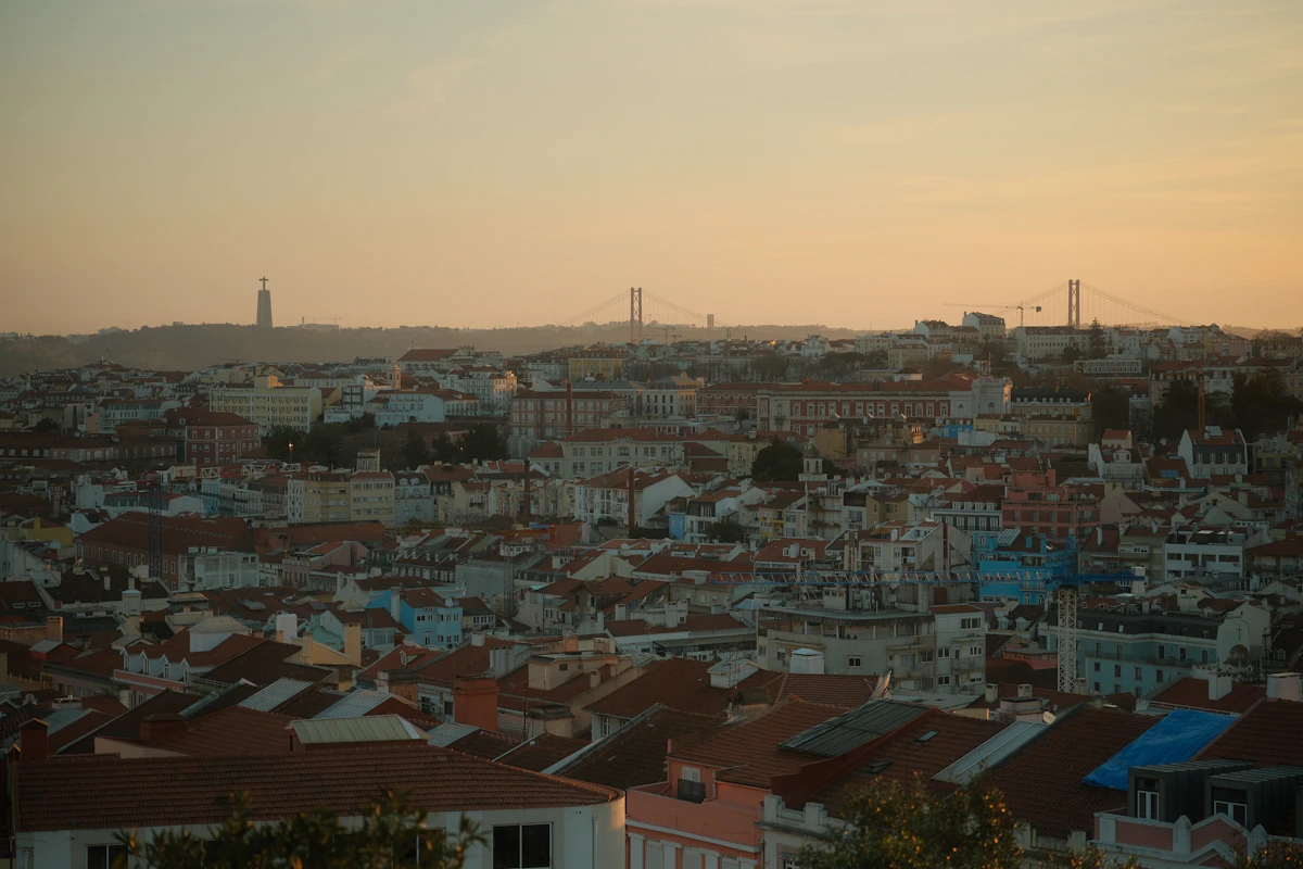 Lisbon's terracotta rooftops, the Tagus and the 25 de Abril Bridge at golden hour