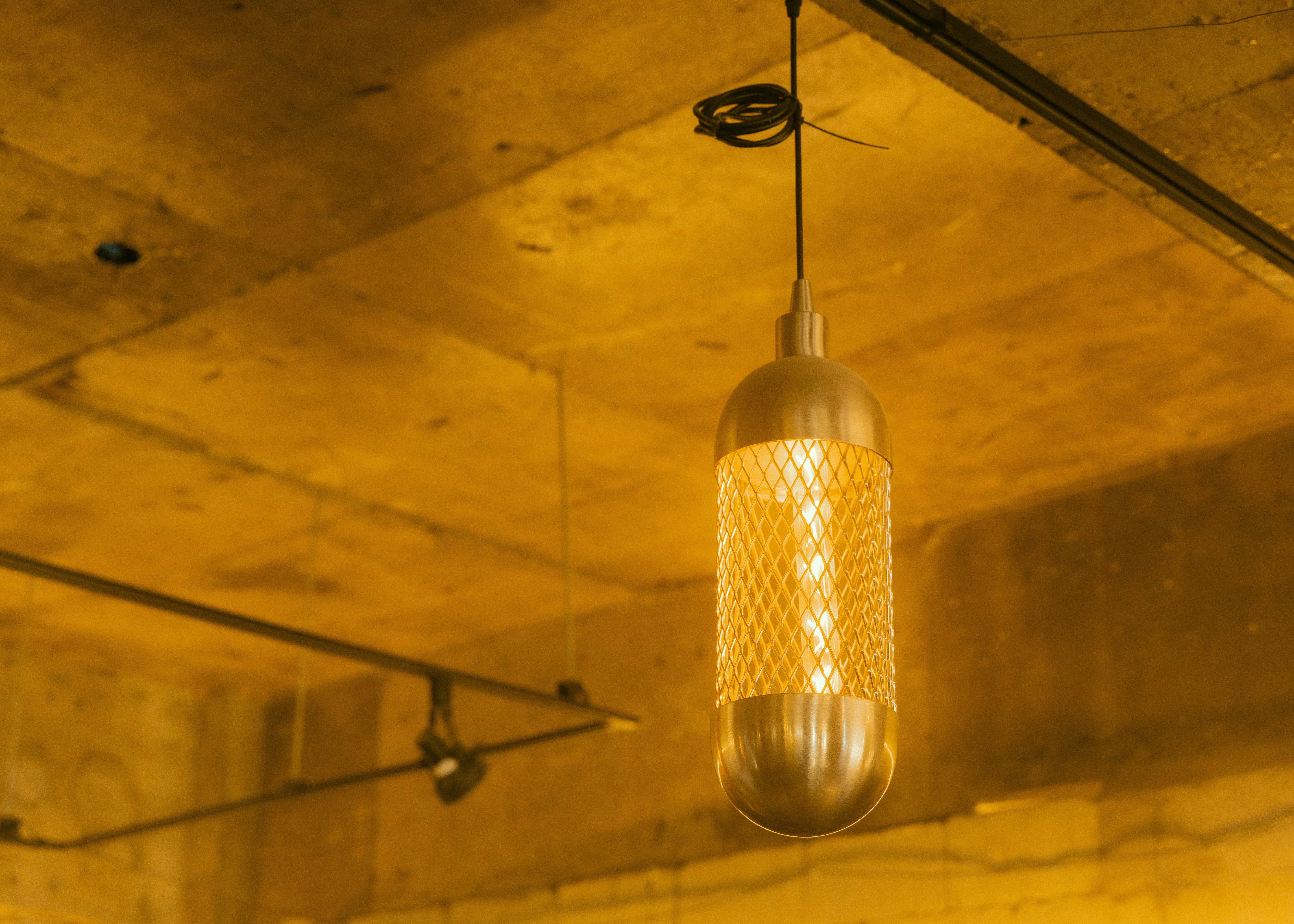 A modern hanging light fixture illuminates a room.
