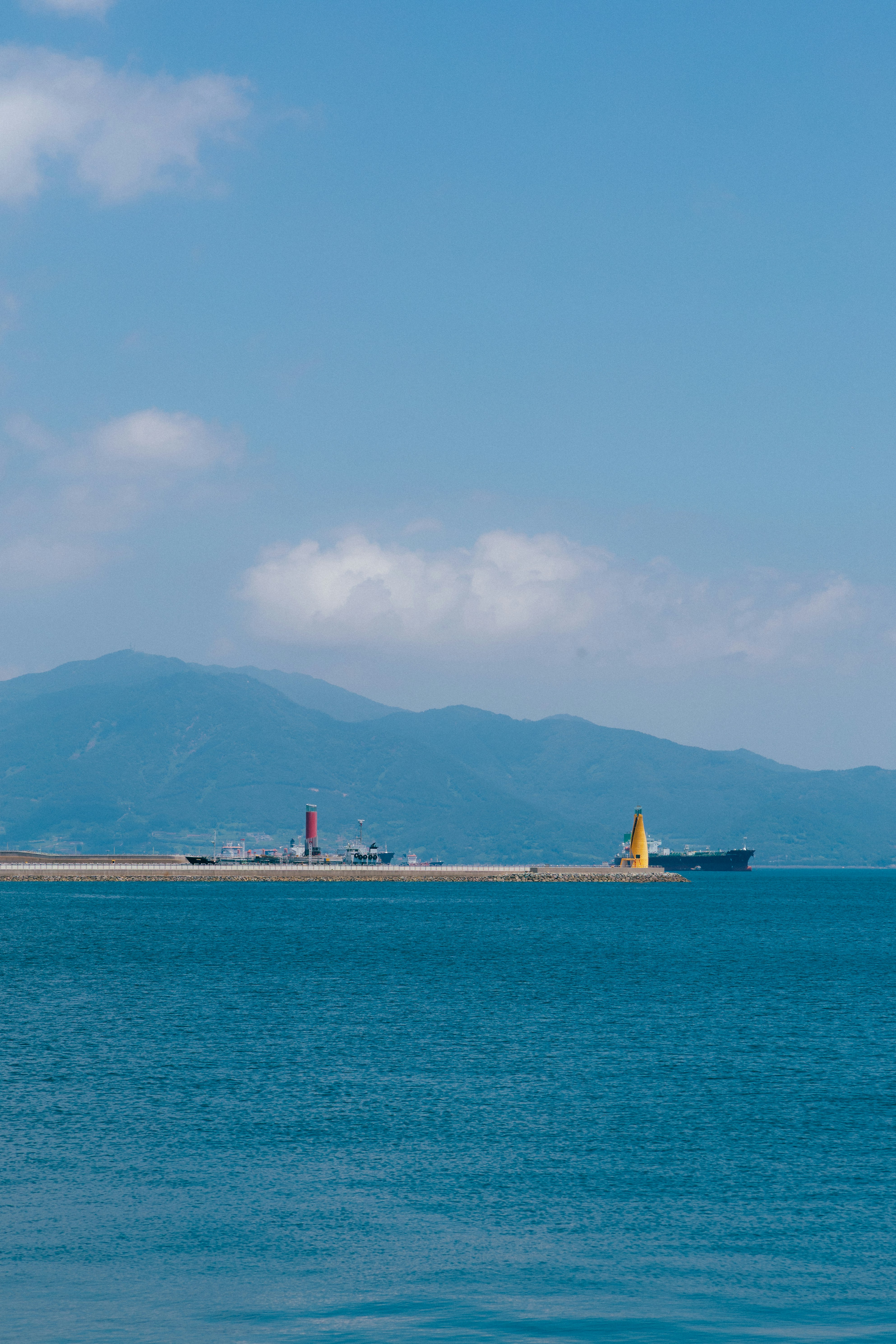 A lighthouse and a ship on the water