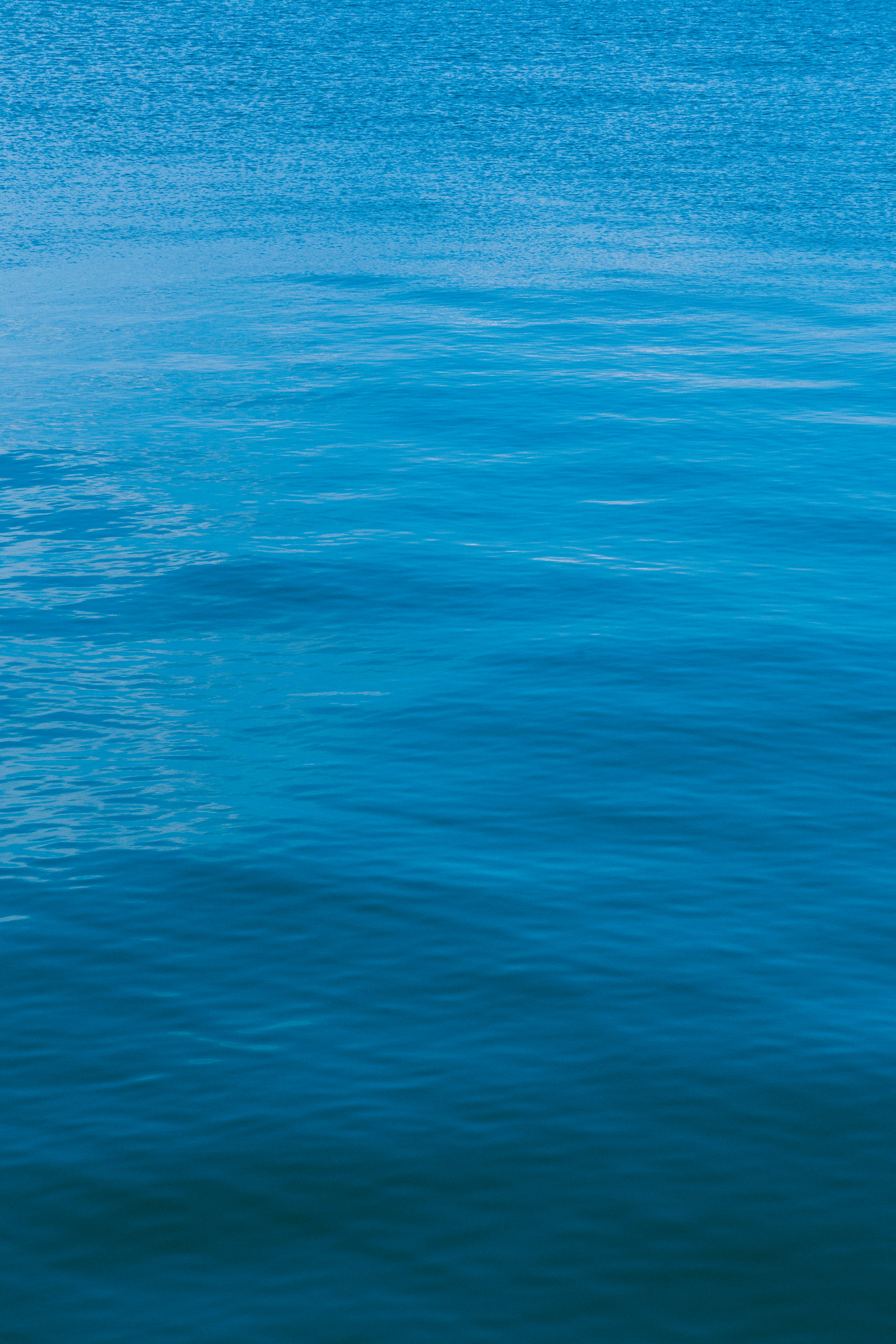 Rippling blue water surface with subtle light reflections