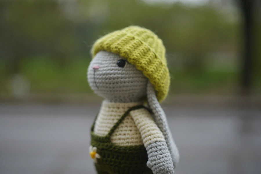 Crocheted bunny in a green hat and overalls, a sample finished project