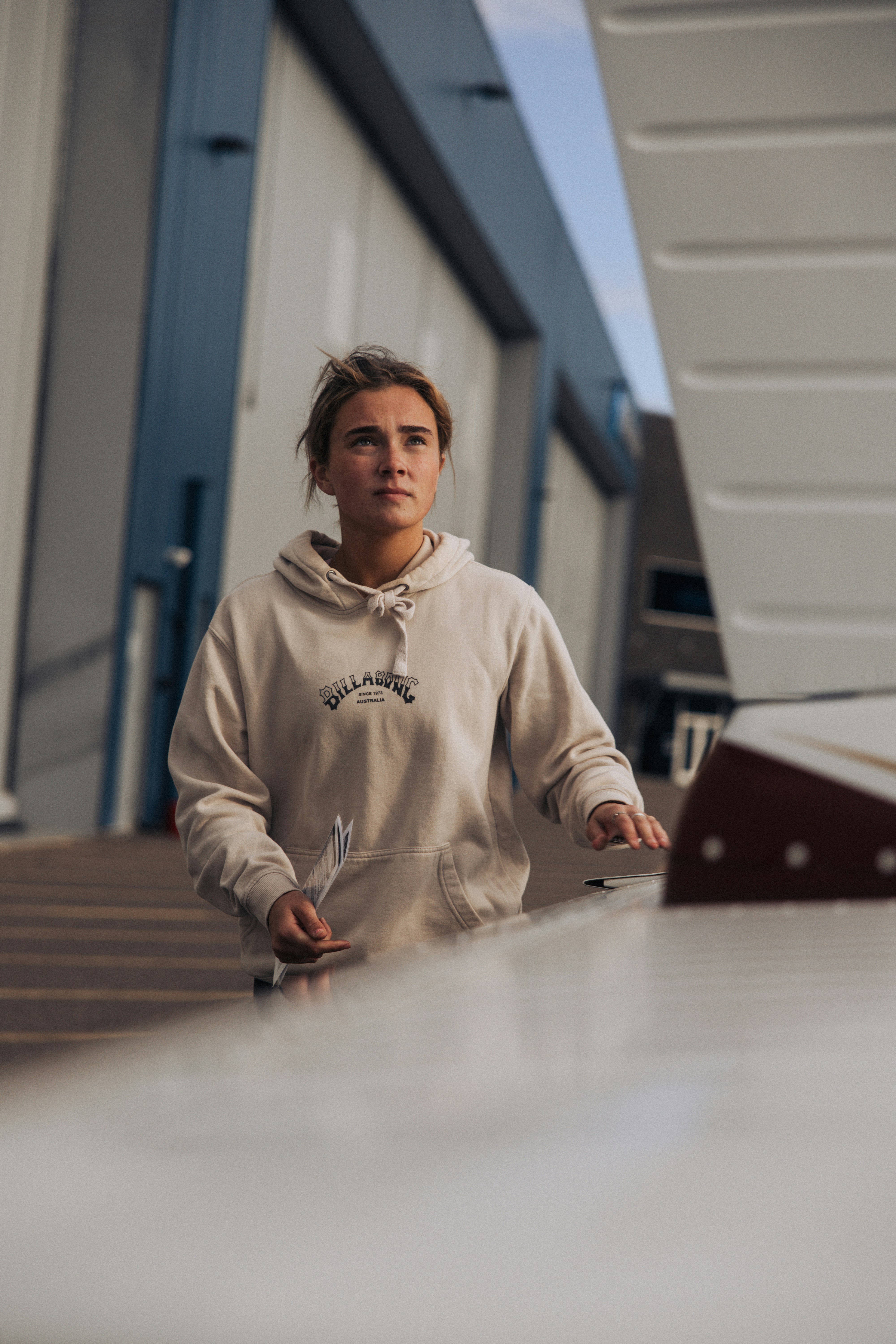 Young woman in a hoodie near a building