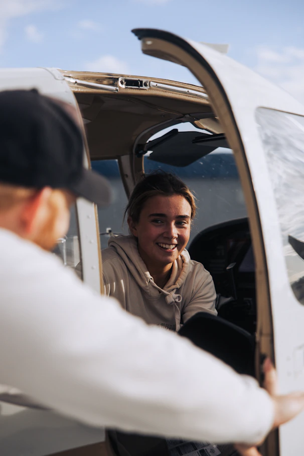 Young woman smiling in airplane cockpit