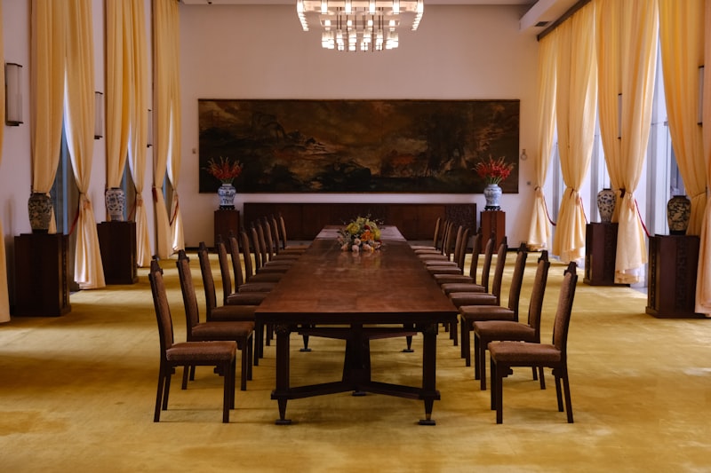 Long wooden table with chairs in a formal room