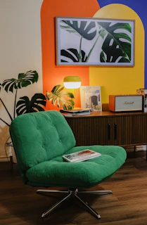 Green chair in a colorful room with plants.
