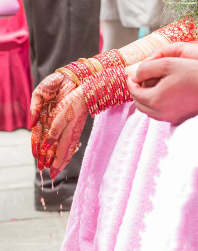 Bride's hands adorned with henna and bangles