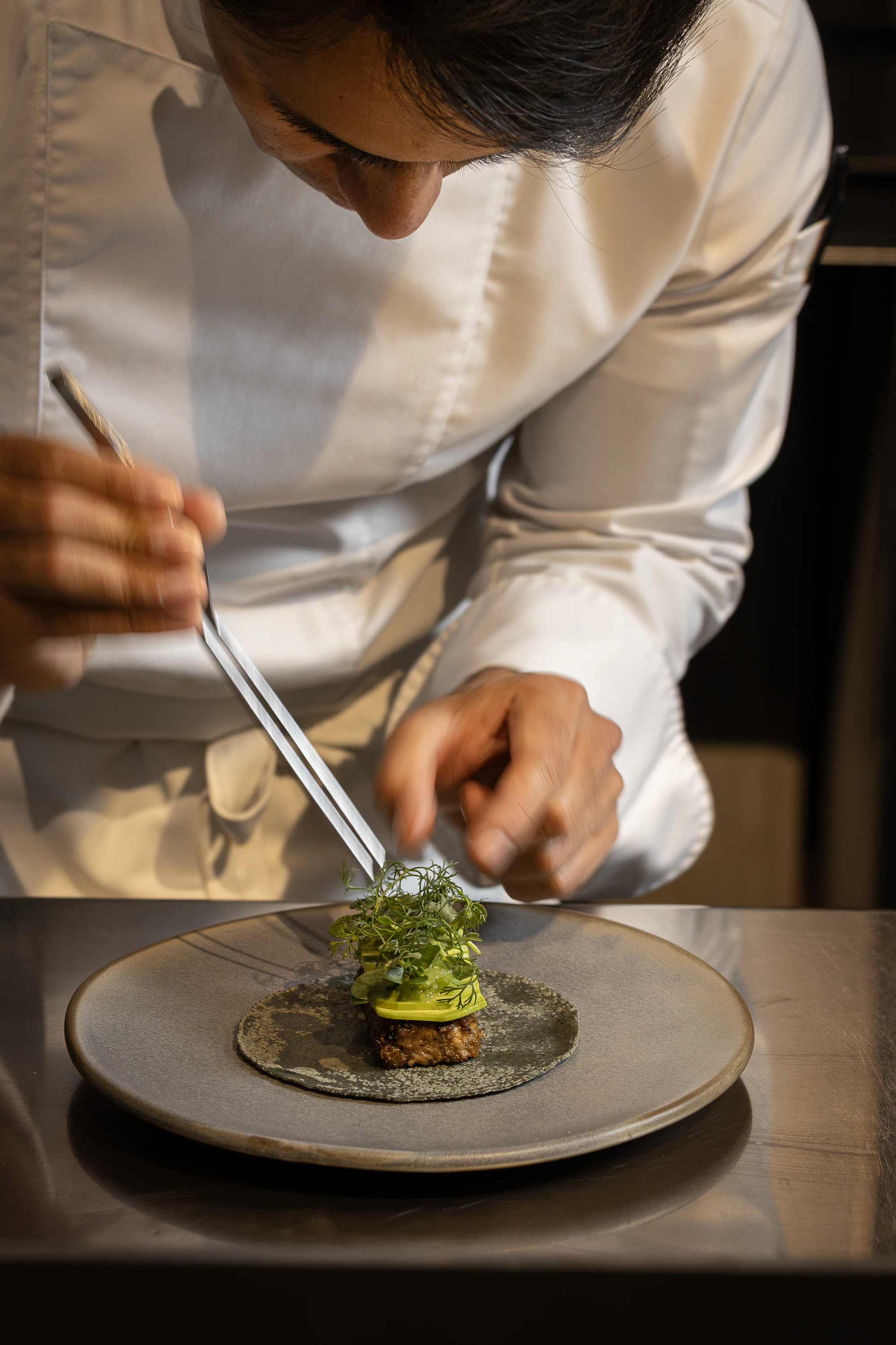 Chef finishing a gourmet dish