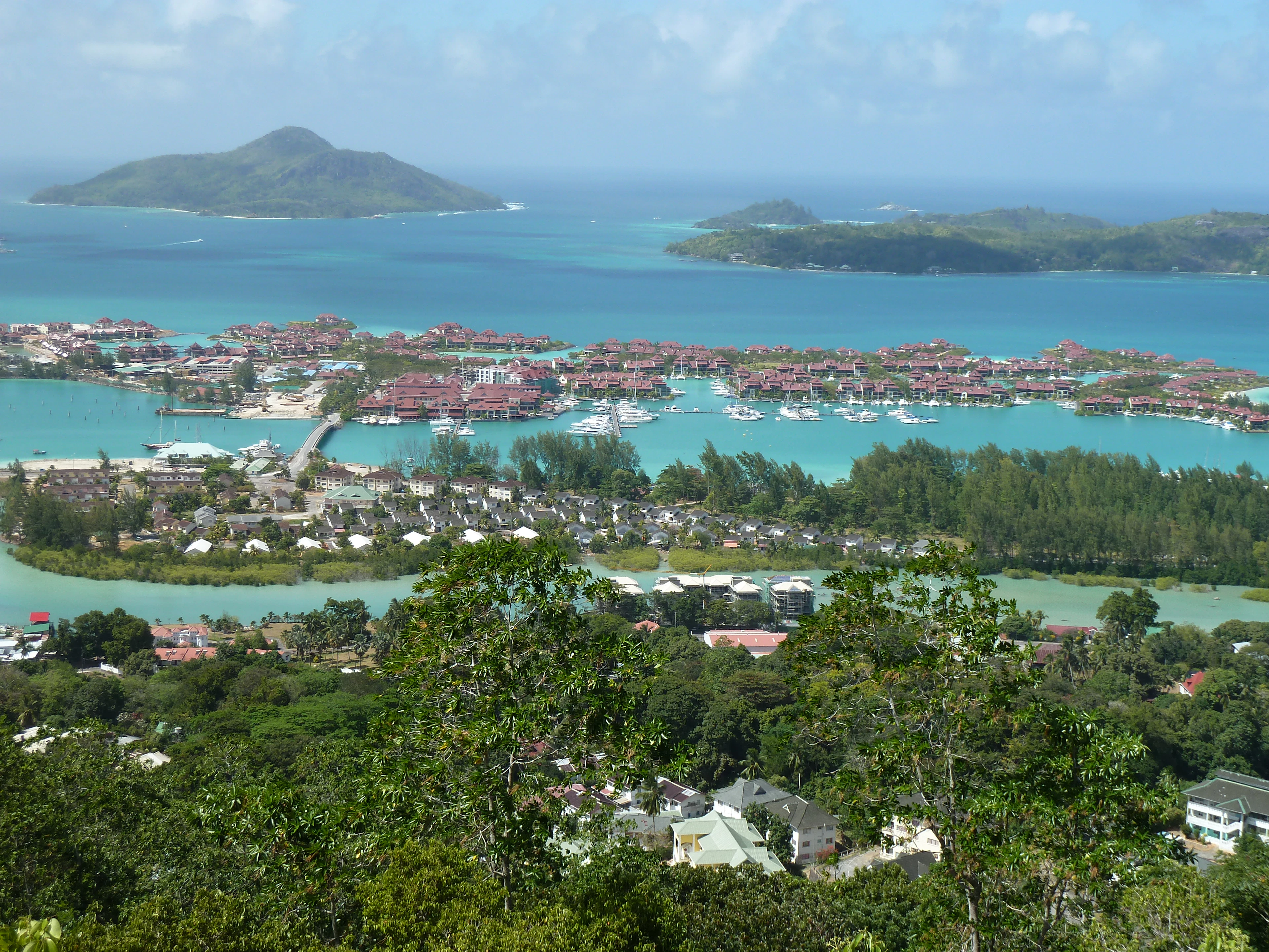 The east coast of Mahe from the hills, the Eden Island marina below and Sainte Anne lying offshore