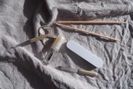 Manicure tools laid out on a white towel.