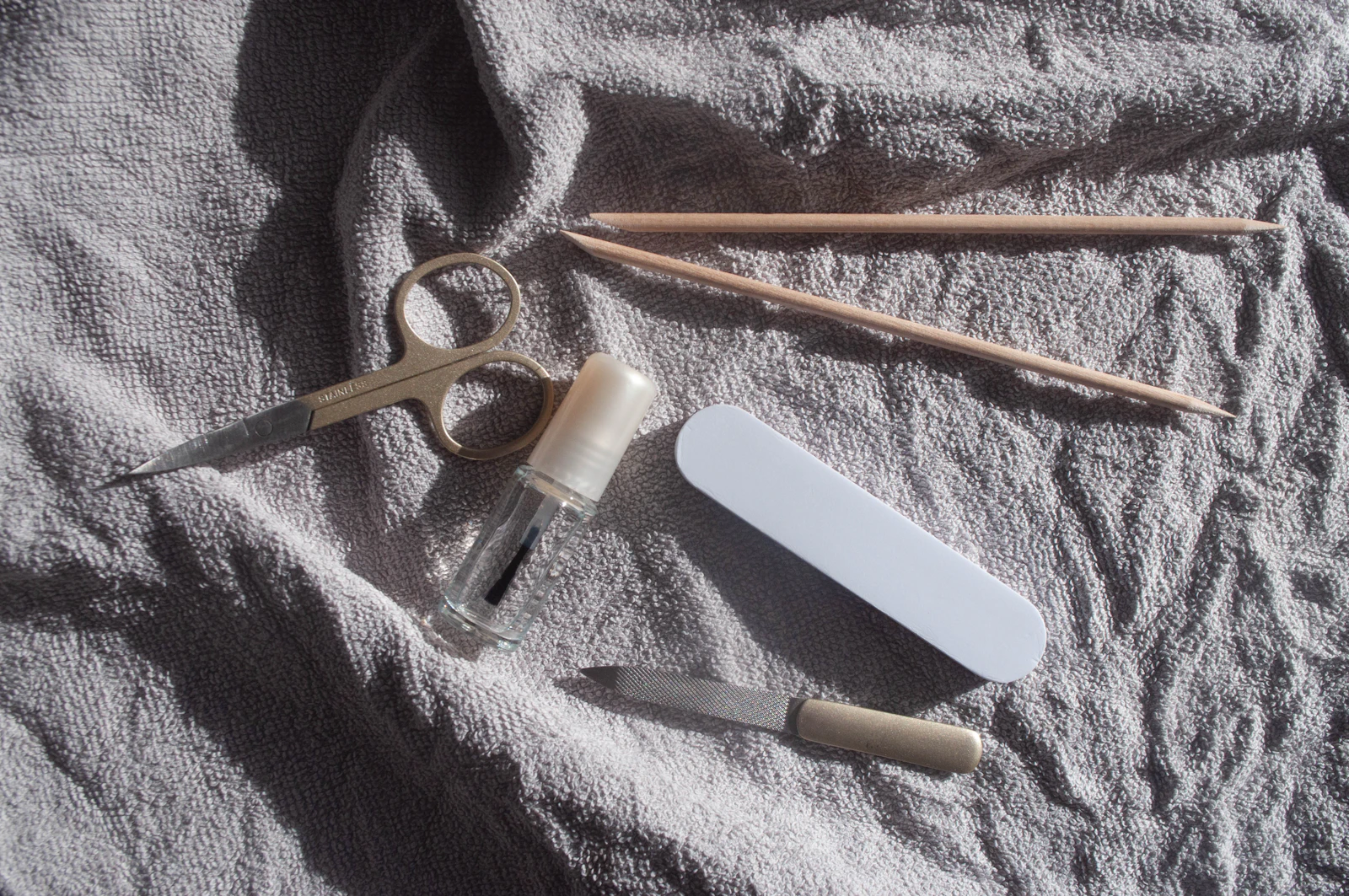 Manicure and nail care tools arranged neatly on a light surface