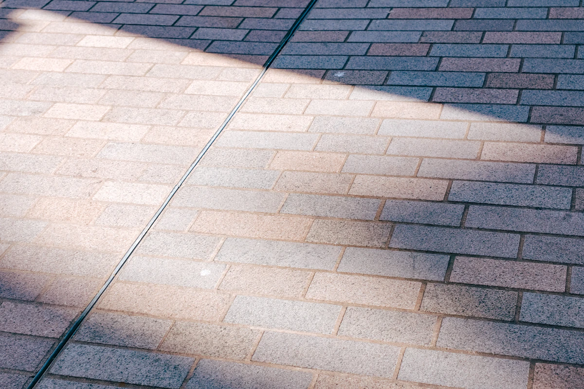 Sunlit brick paver walkway with clean, even joints