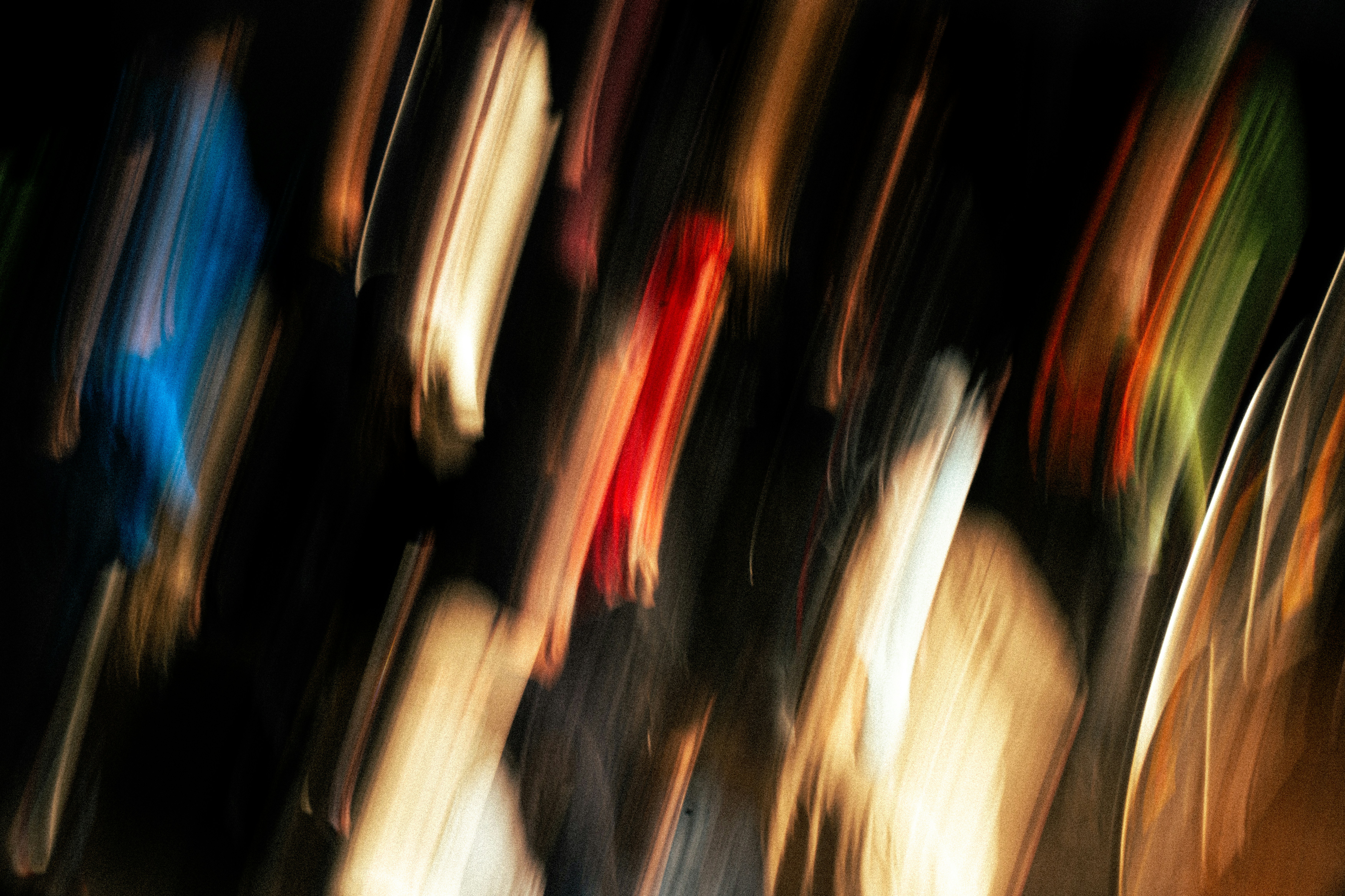 Abstract streaks of colorful lights against dark background