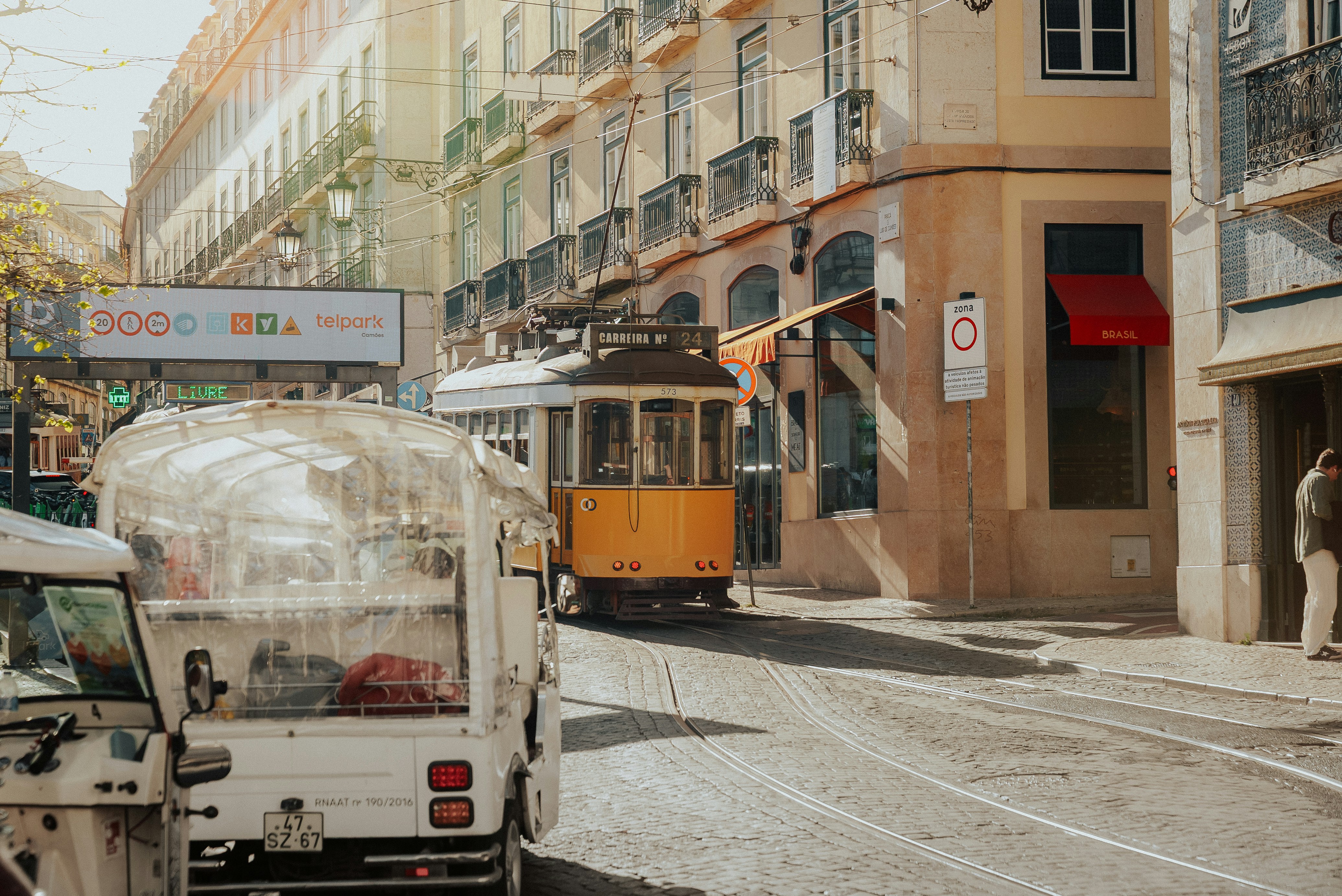 yellow tram on a sunny street in Lisbon, Portugal