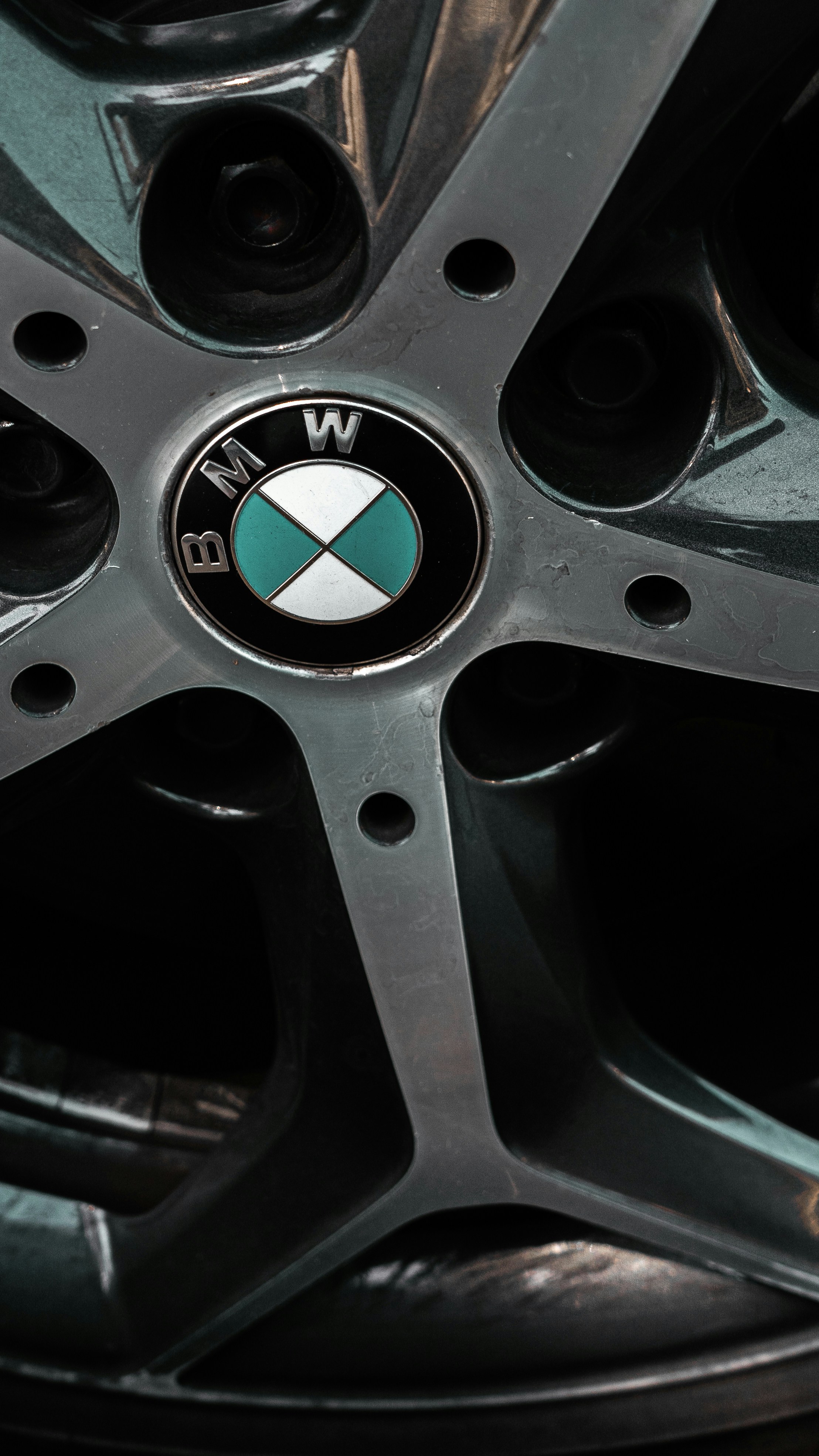 Close-up of a BMW car wheel with logo.