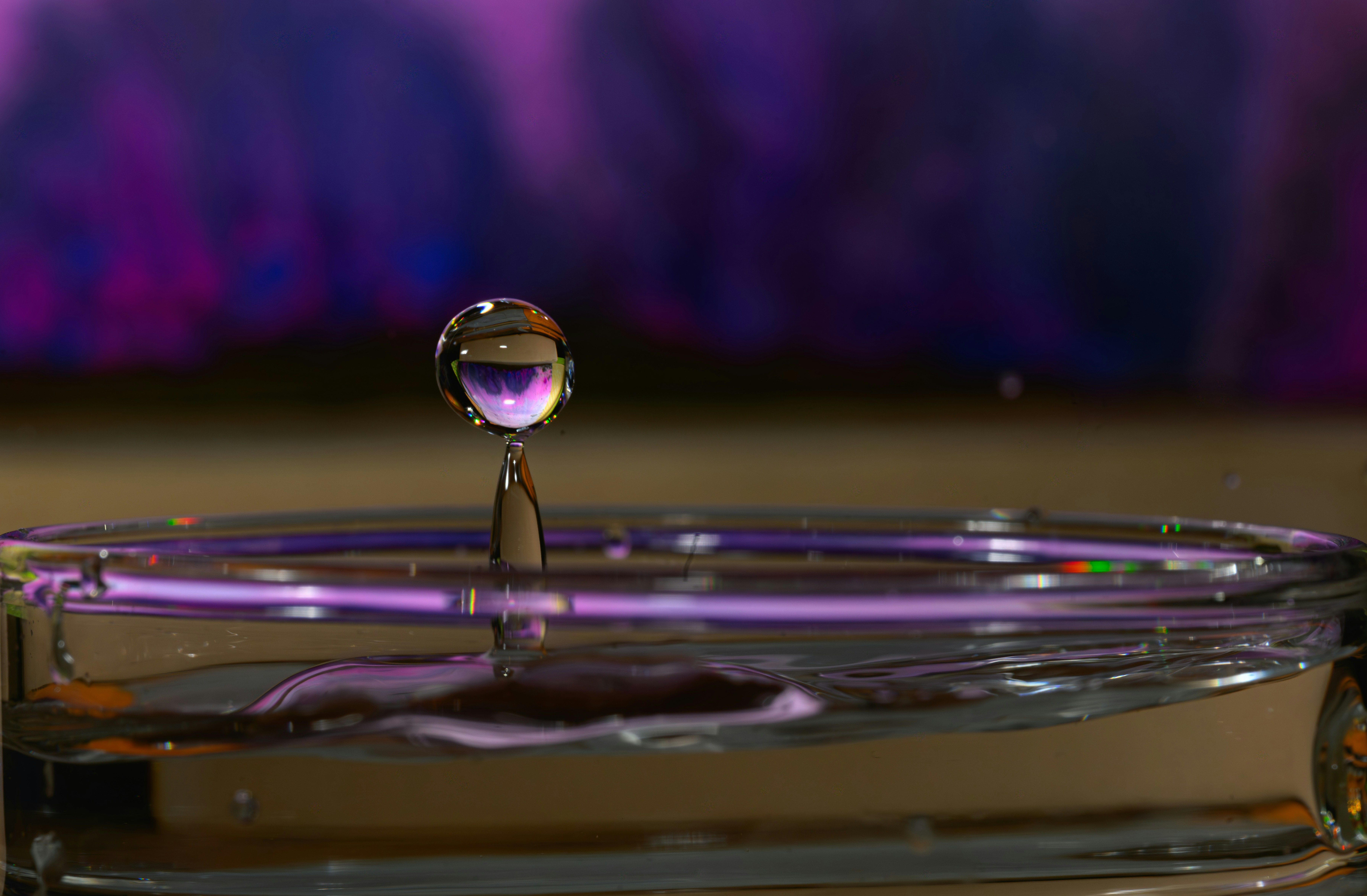 Water droplet suspended above a surface.
